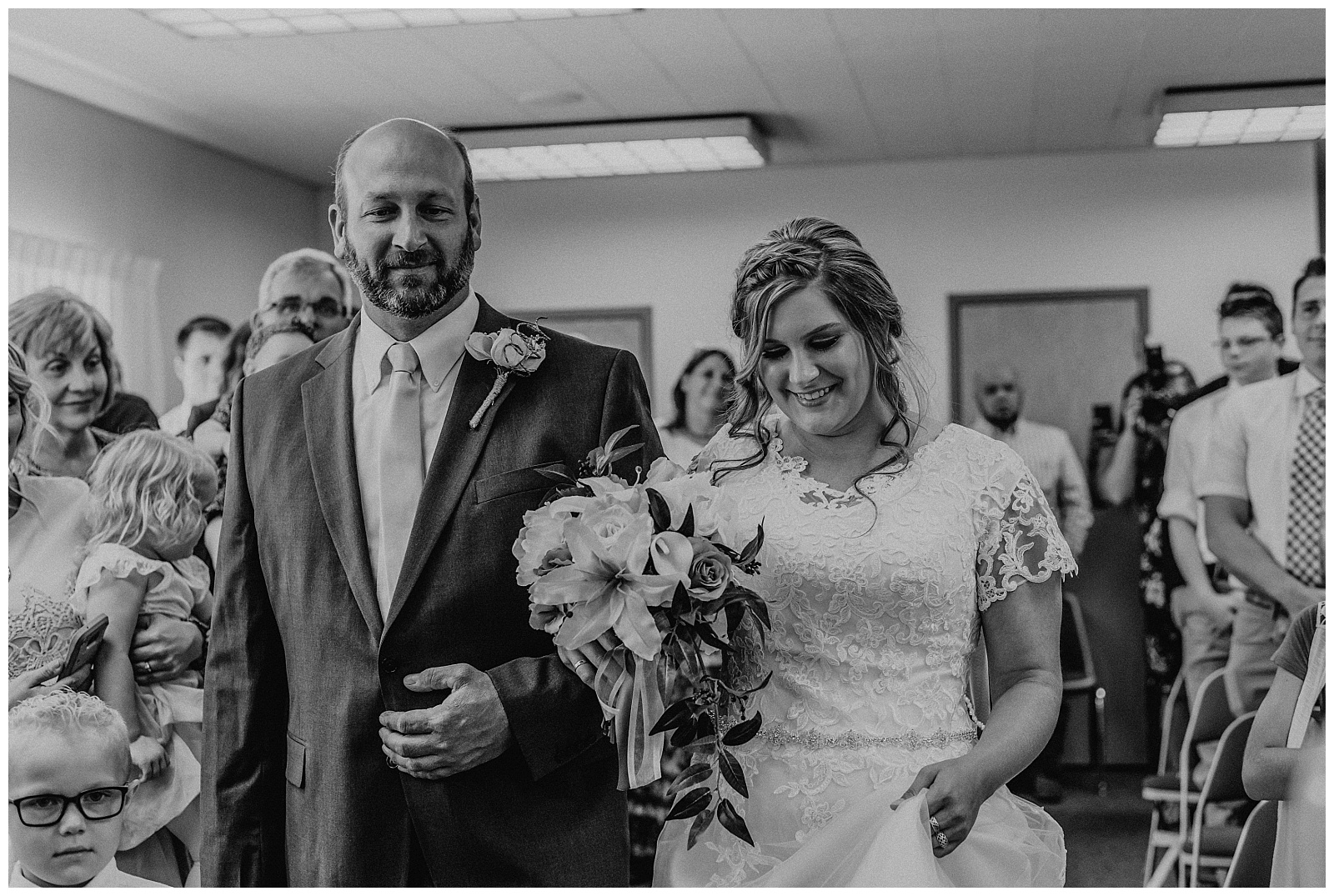 father and bride walking down aisle