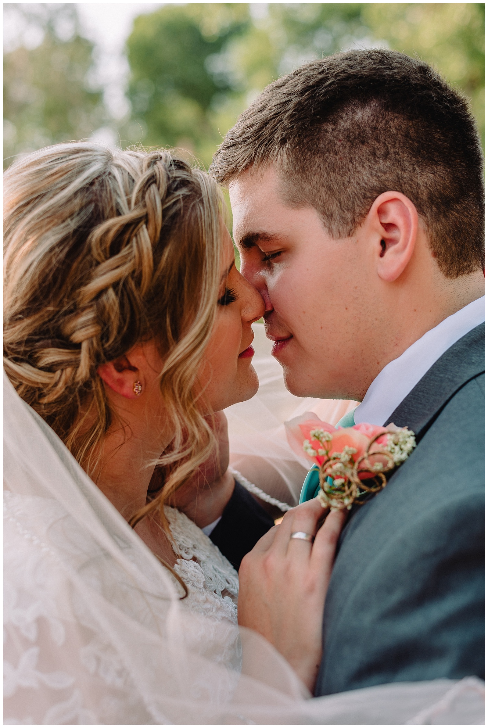 bride and groom outdoor wedding closeup kissing