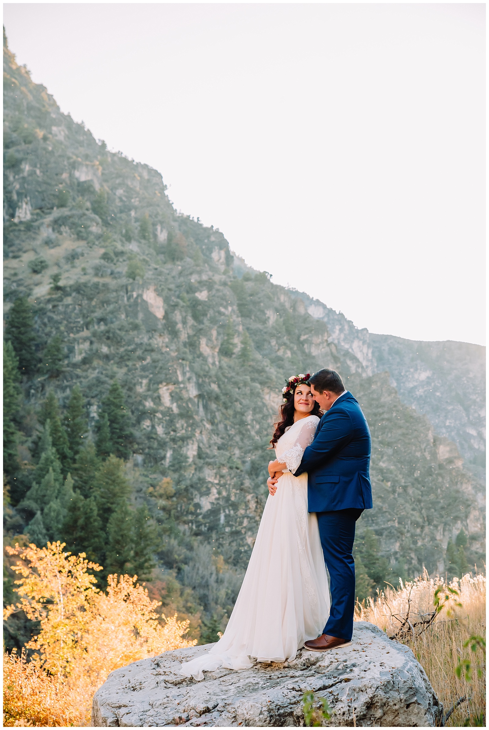 bride and groom standing on rock in logan canyon