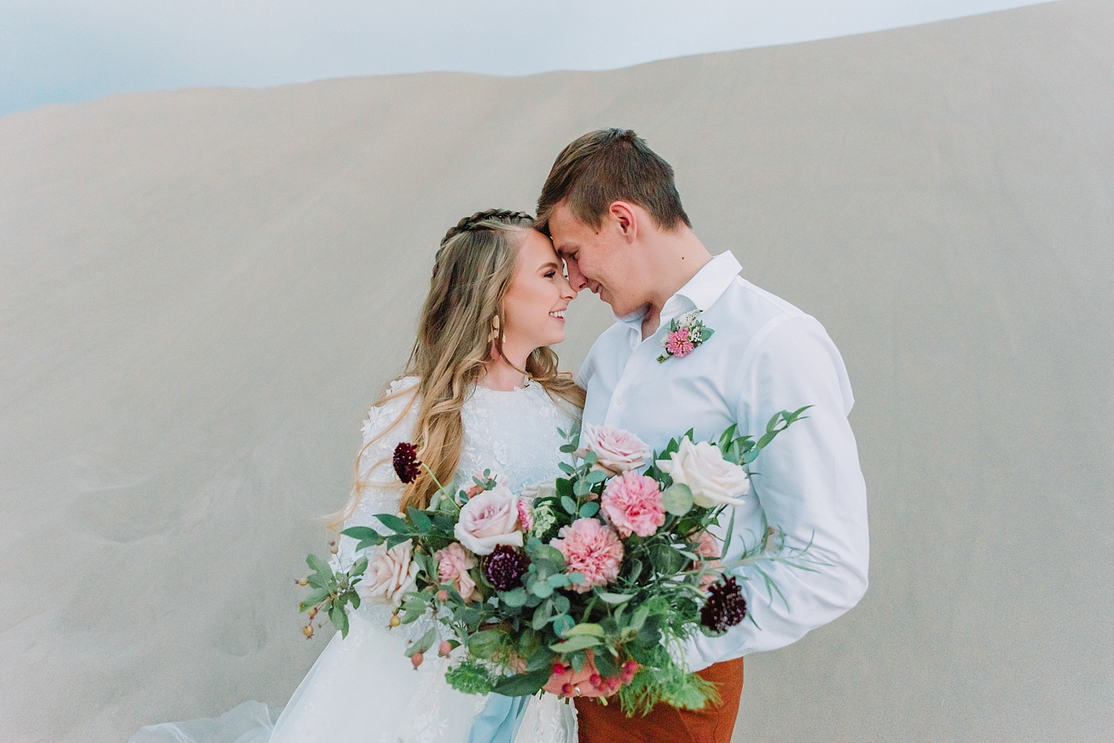 couple foreheads together on wedding day during beach inspired elopement