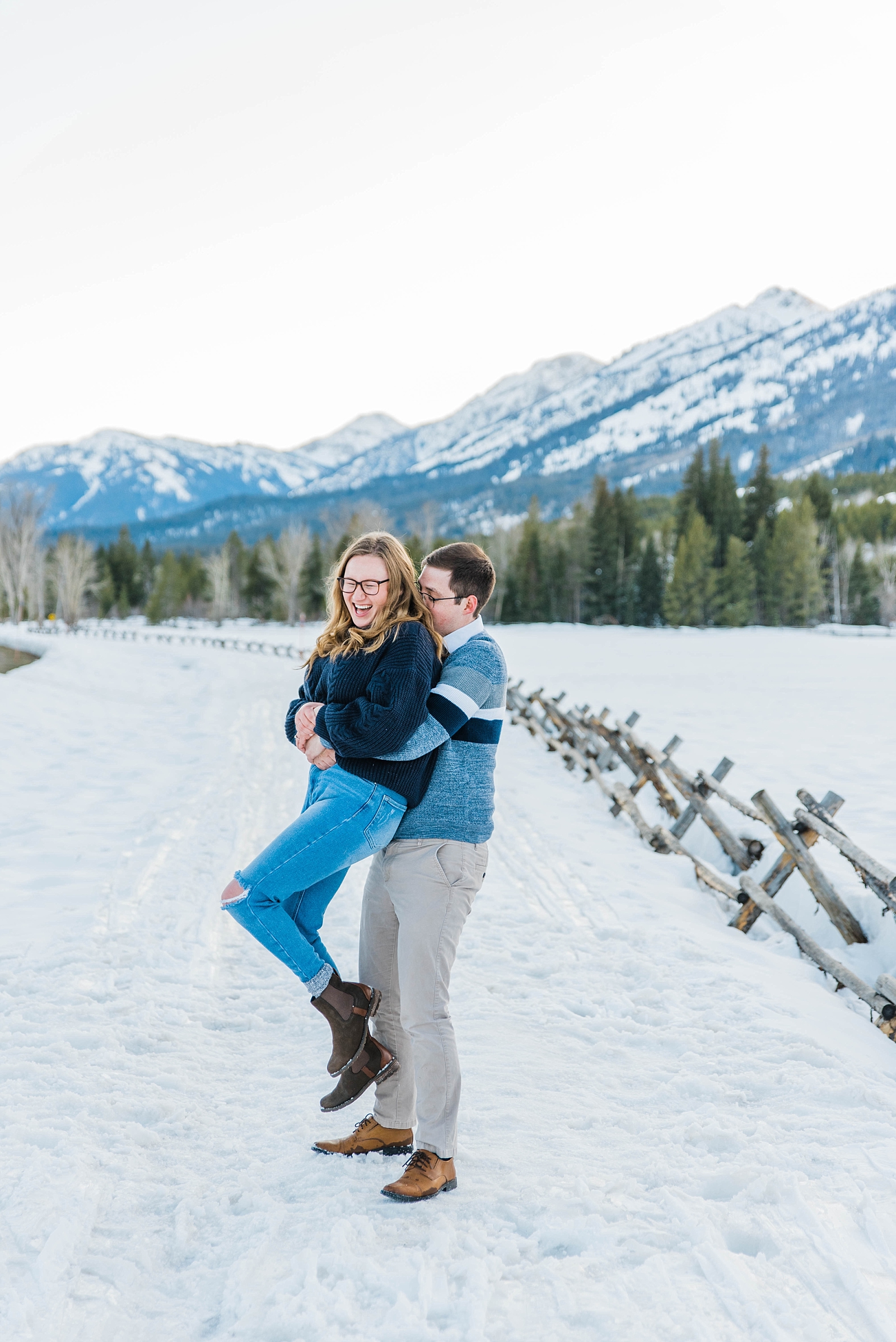 Jackson Hole Engagement Photos couple laughing and having fun together during winter engagement session