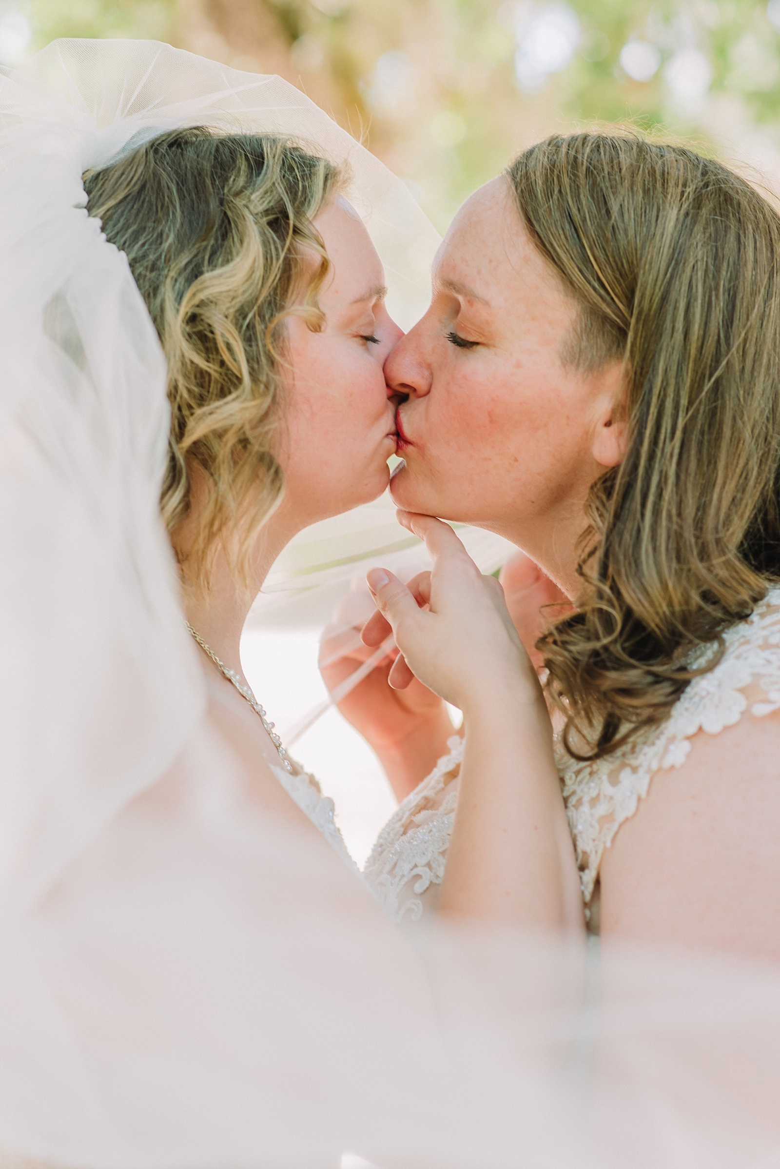 kissing same sex couple on wedding day