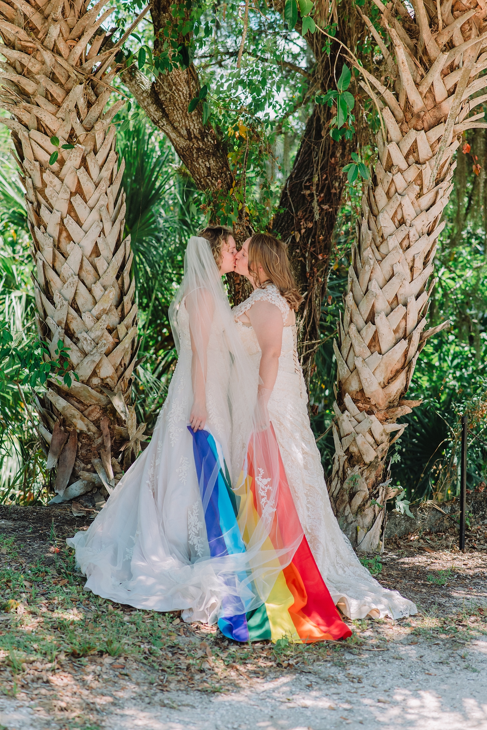 lesbian couple on wedding day with pride flag