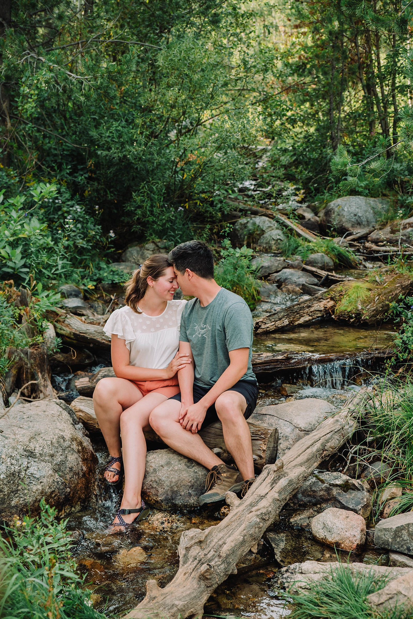 couple sits in small stream