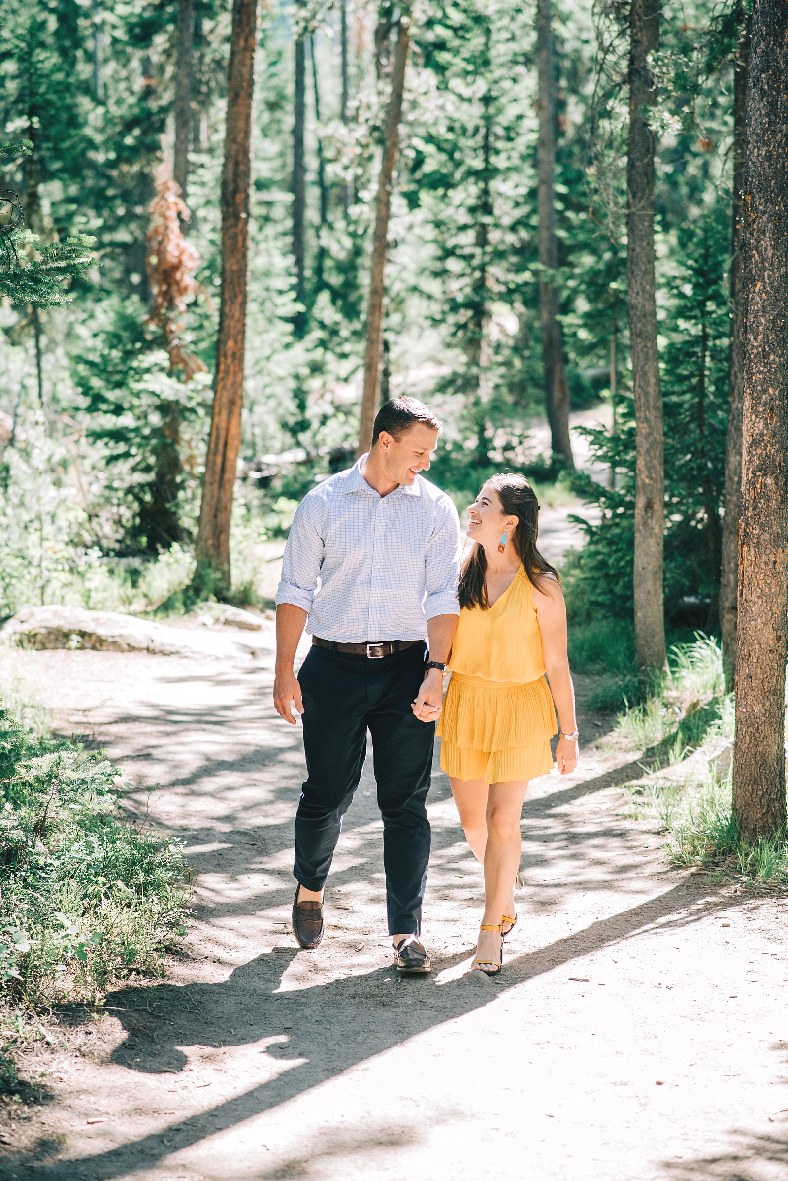 newlyweds walking together on a path in Jackson Hole for their Jackson Hole honeymoon portraits