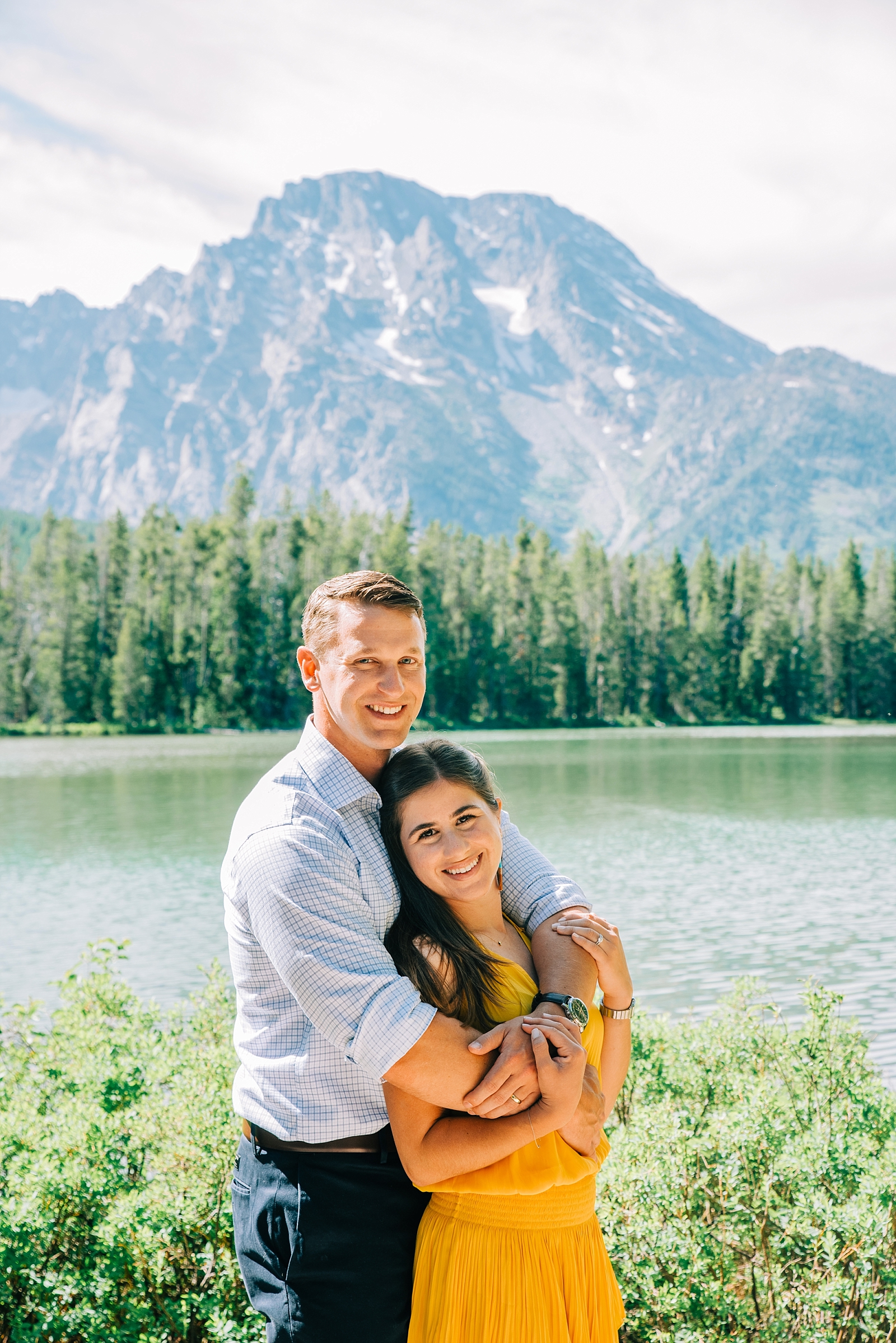 String Lake newly wed session with honeymooners embracing each other with the mountains and lake in the background