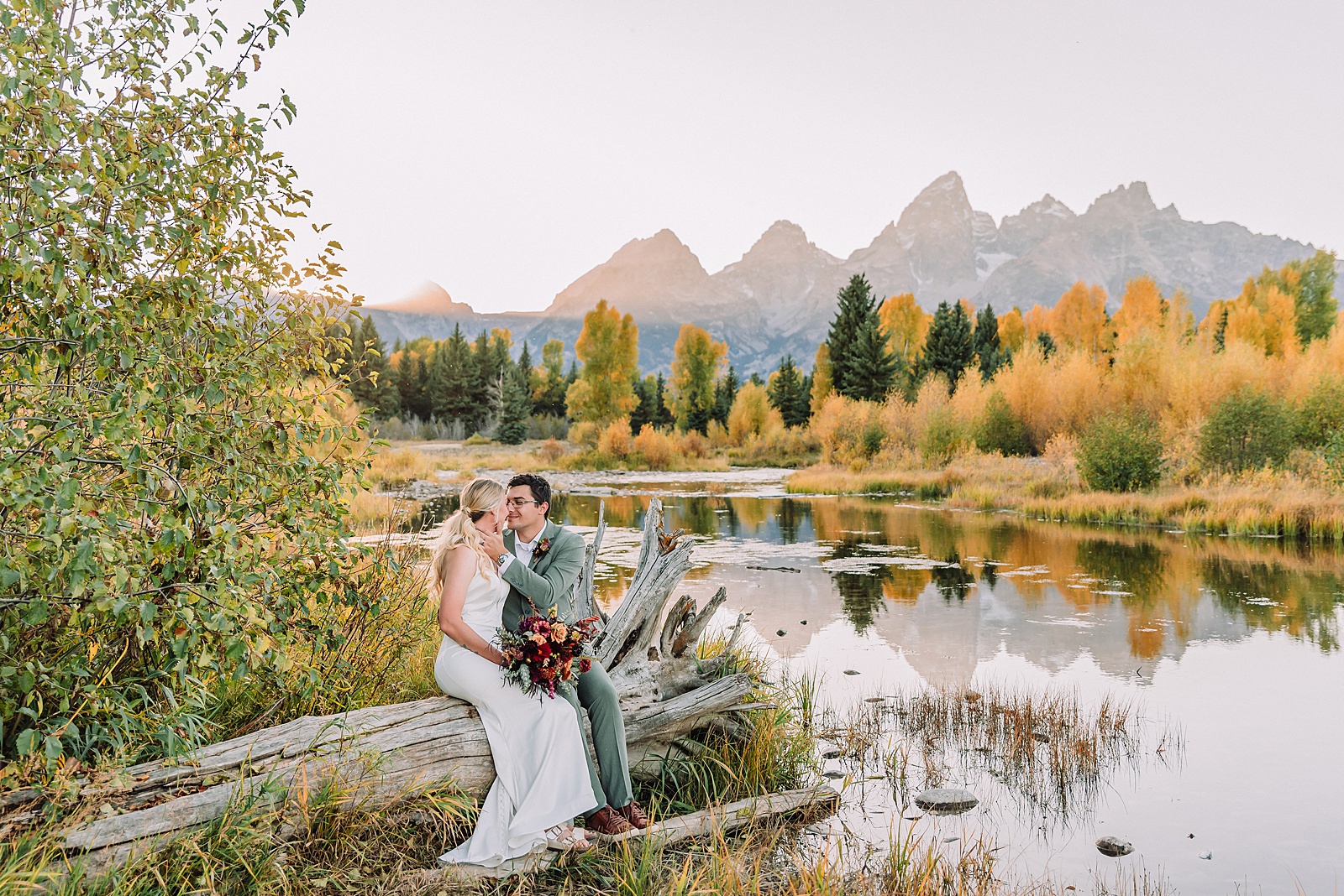 wedding couple posing in front of the grand teton mountains