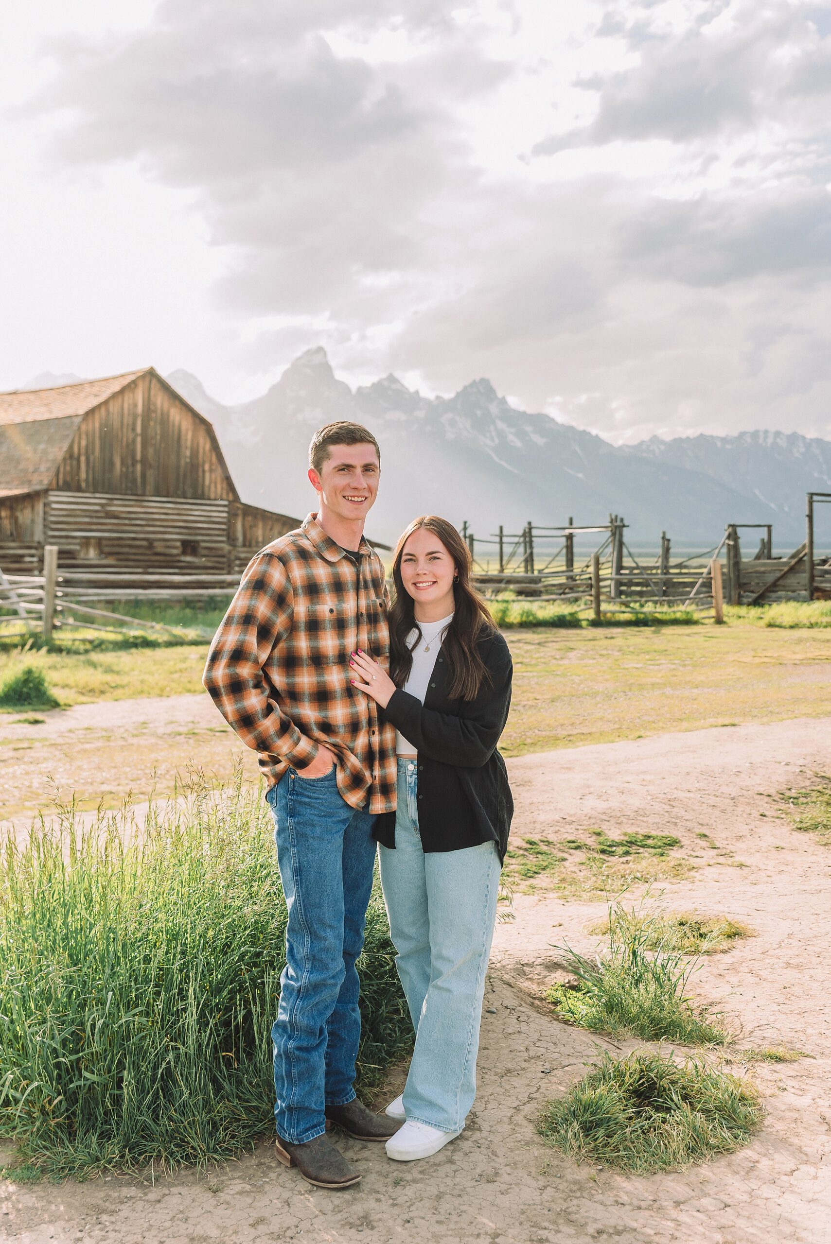 Jackson Hole Engagement Photographer at Mormon Row North Couple poses ideas for natural and candid engagement photos outdoors Jackson Hole engagement photos at Schwabacher Landing Mormon Row North engagement session with Jackson Hole engagement photographer Couple poses ideas for relaxed mountain engagement sessions