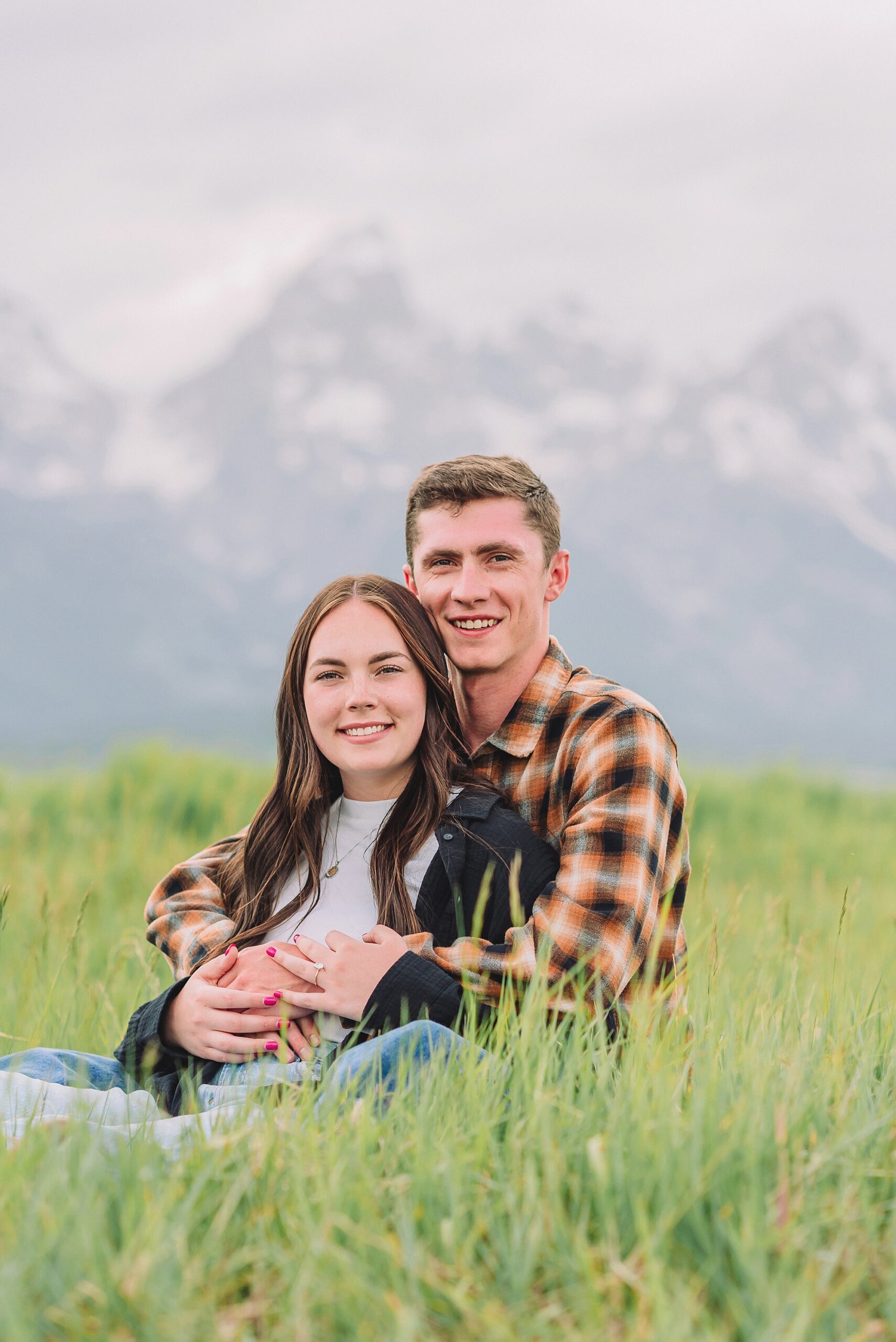 Jackson Hole Engagement Photographer at Mormon Row North Couple poses ideas for natural and candid engagement photos outdoors Jackson Hole engagement photos at Schwabacher Landing Mormon Row North engagement session with Jackson Hole engagement photographer Couple poses ideas for relaxed mountain engagement sessions