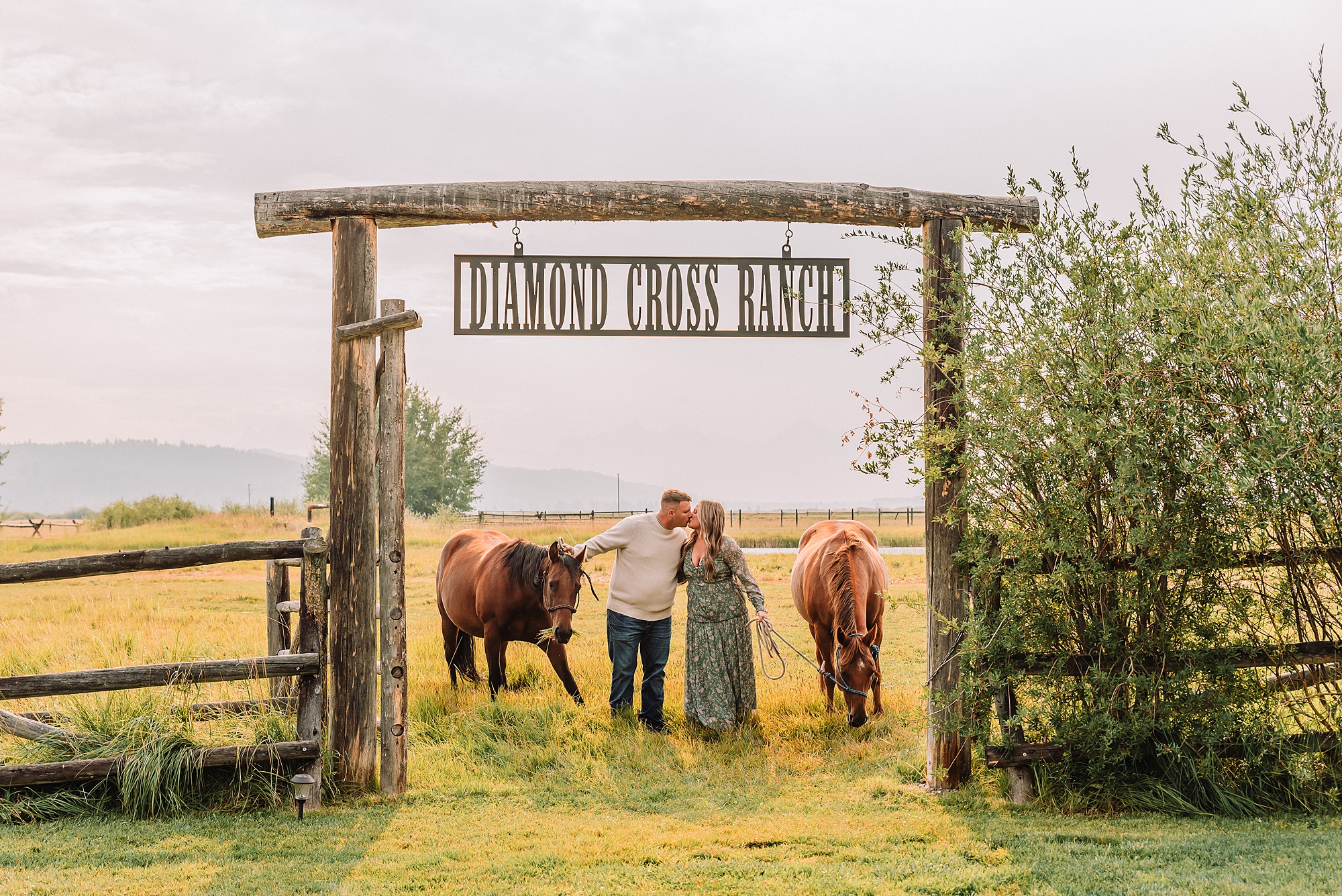 Couple poses with horses at Diamond Cross Ranch