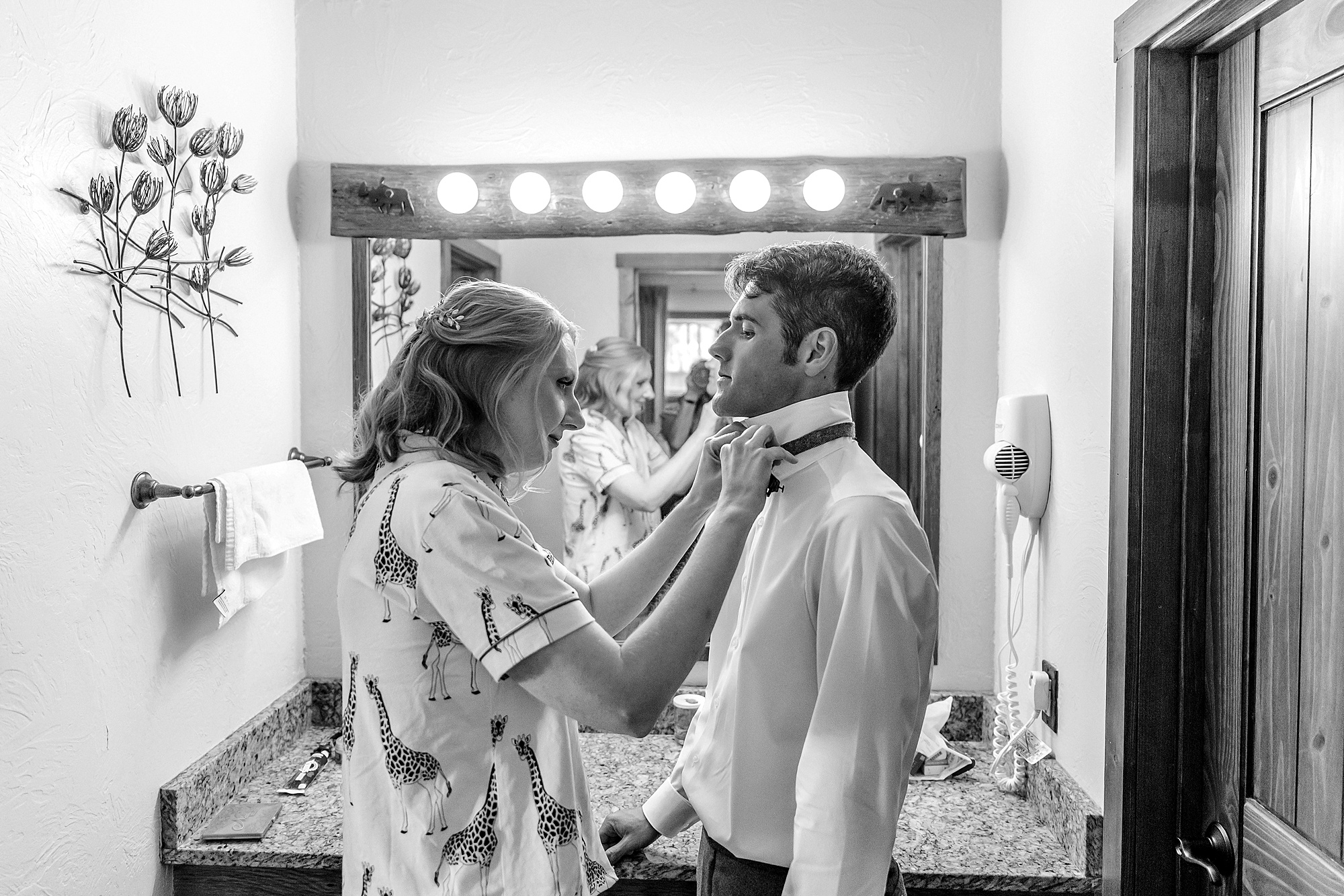 bride helps groom put on his bowtie at signal mountain lodge
