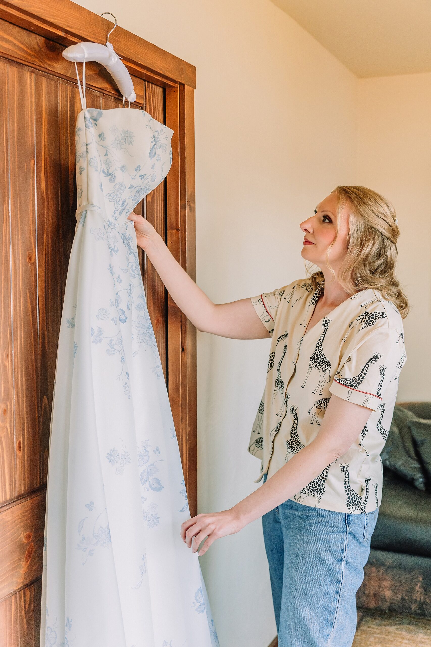 bride poses with wedding dress in cabin 