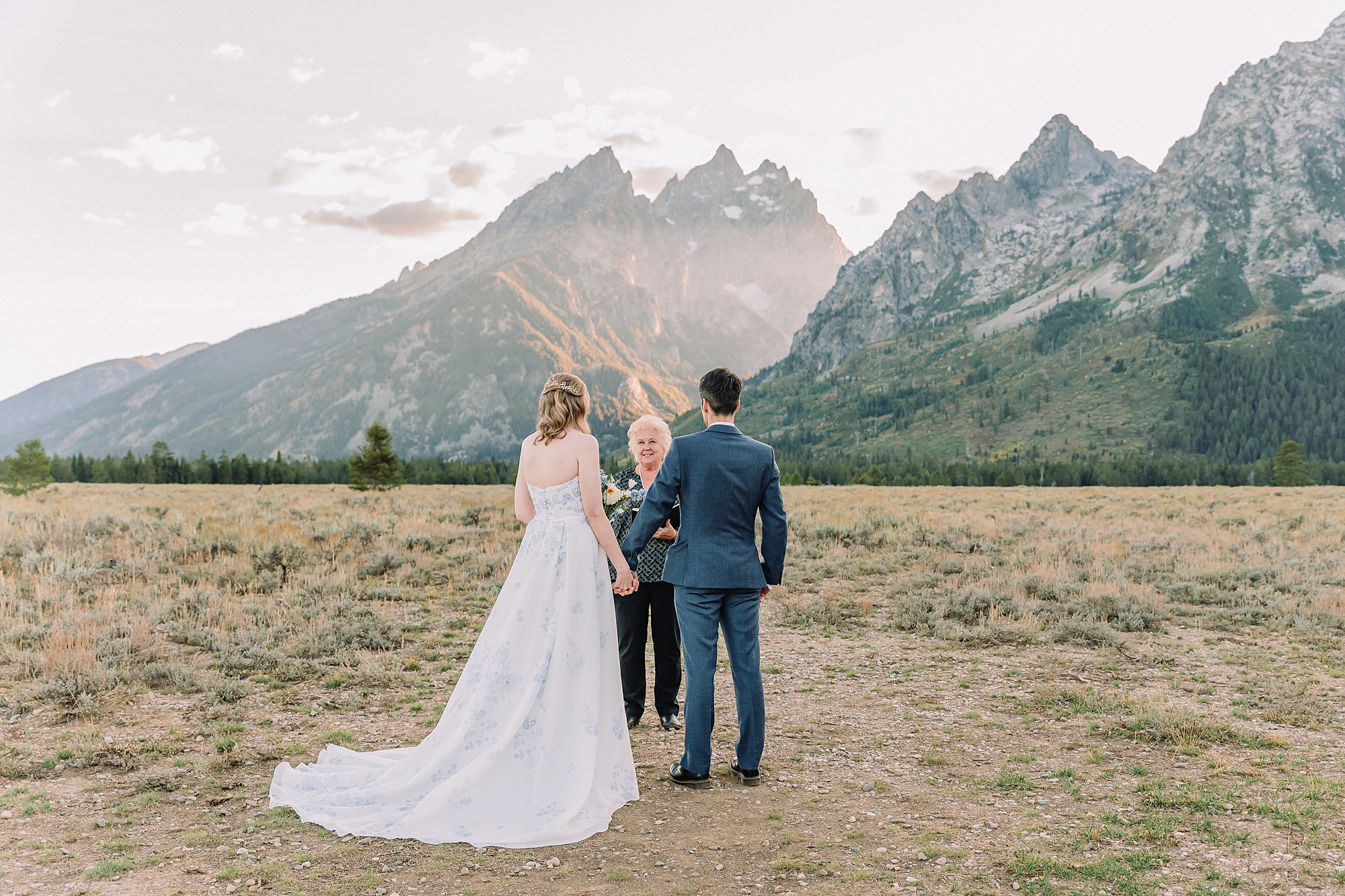 bride and groom share vows while wedding officiant performs ceremony at Cathedral Group Turnout
