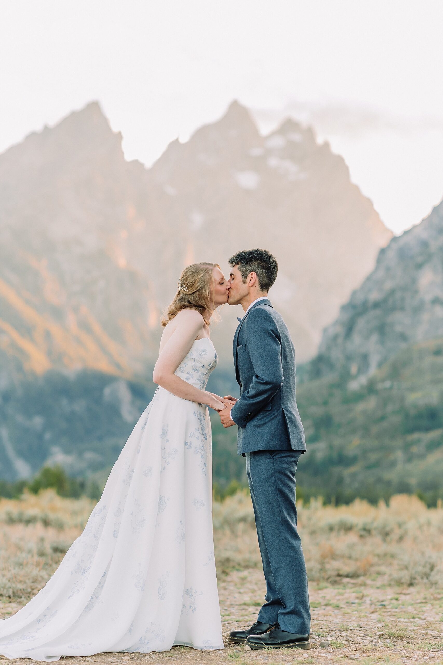 newlywed couple kisses after wedding ceremony at Cathedral Group Turnout