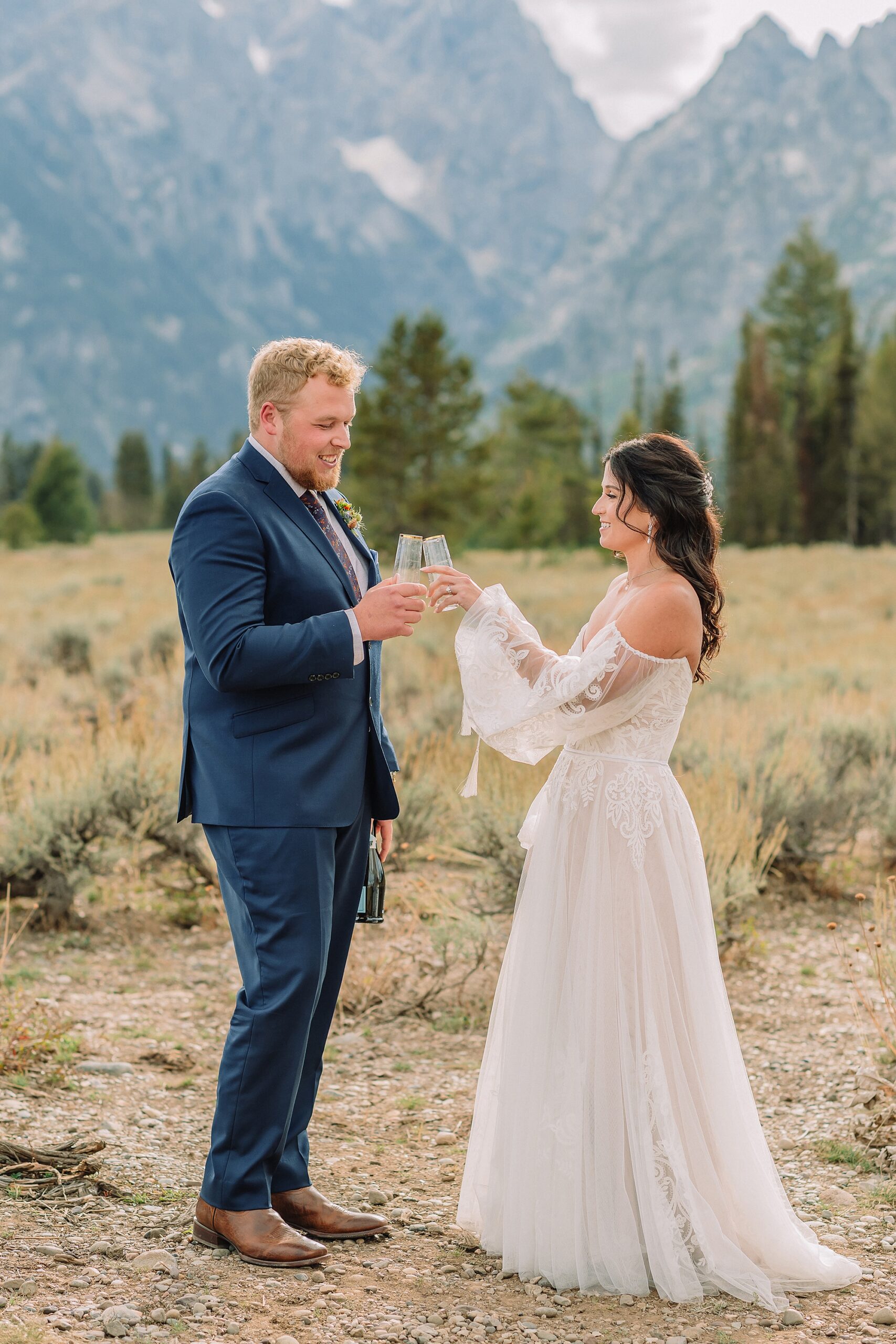 Bride and Groom pop champagne for a toast at Mountain View Turnout in Grand Teton National Park