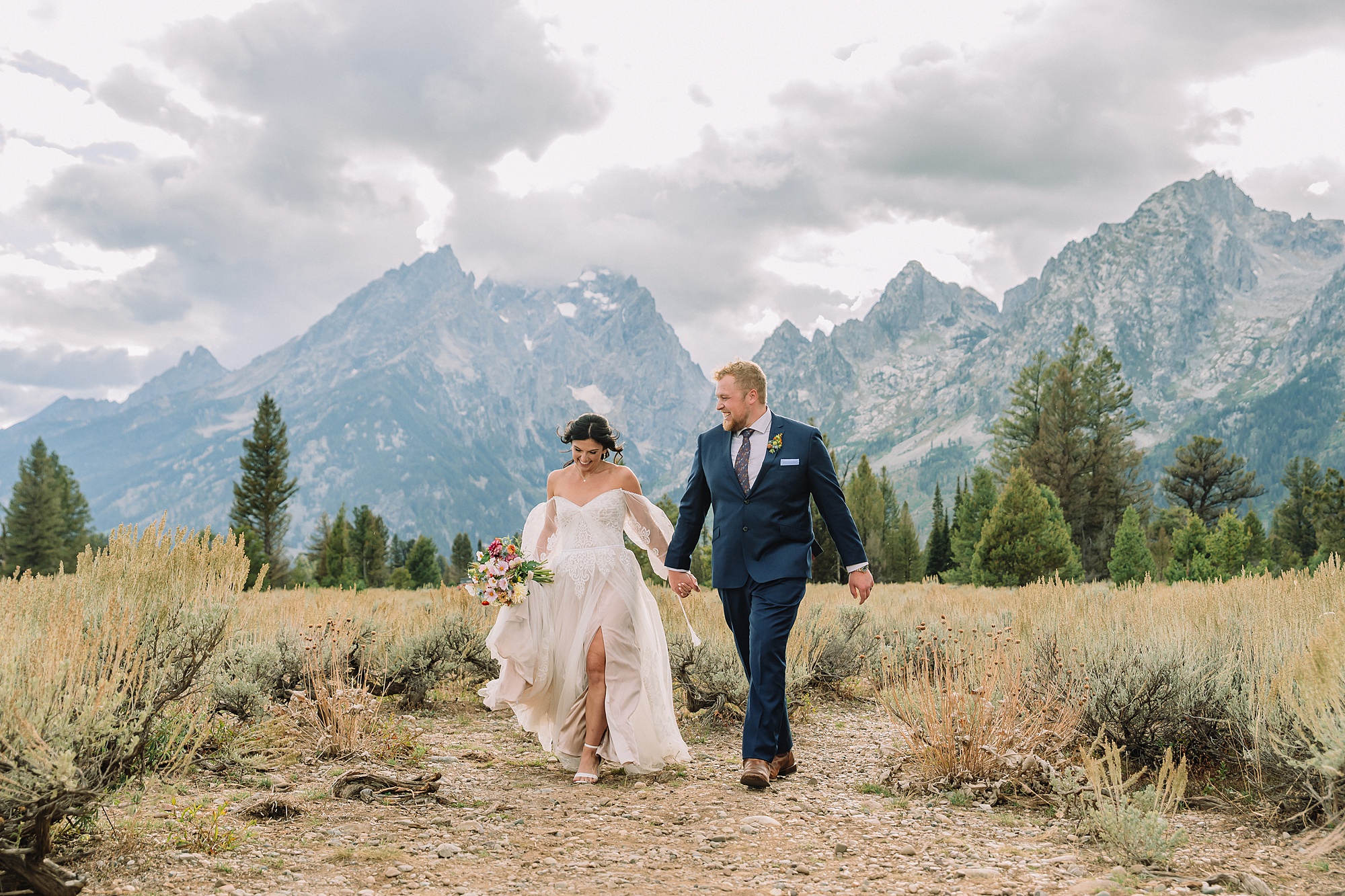 bride and groom walk towards the camera with smiles