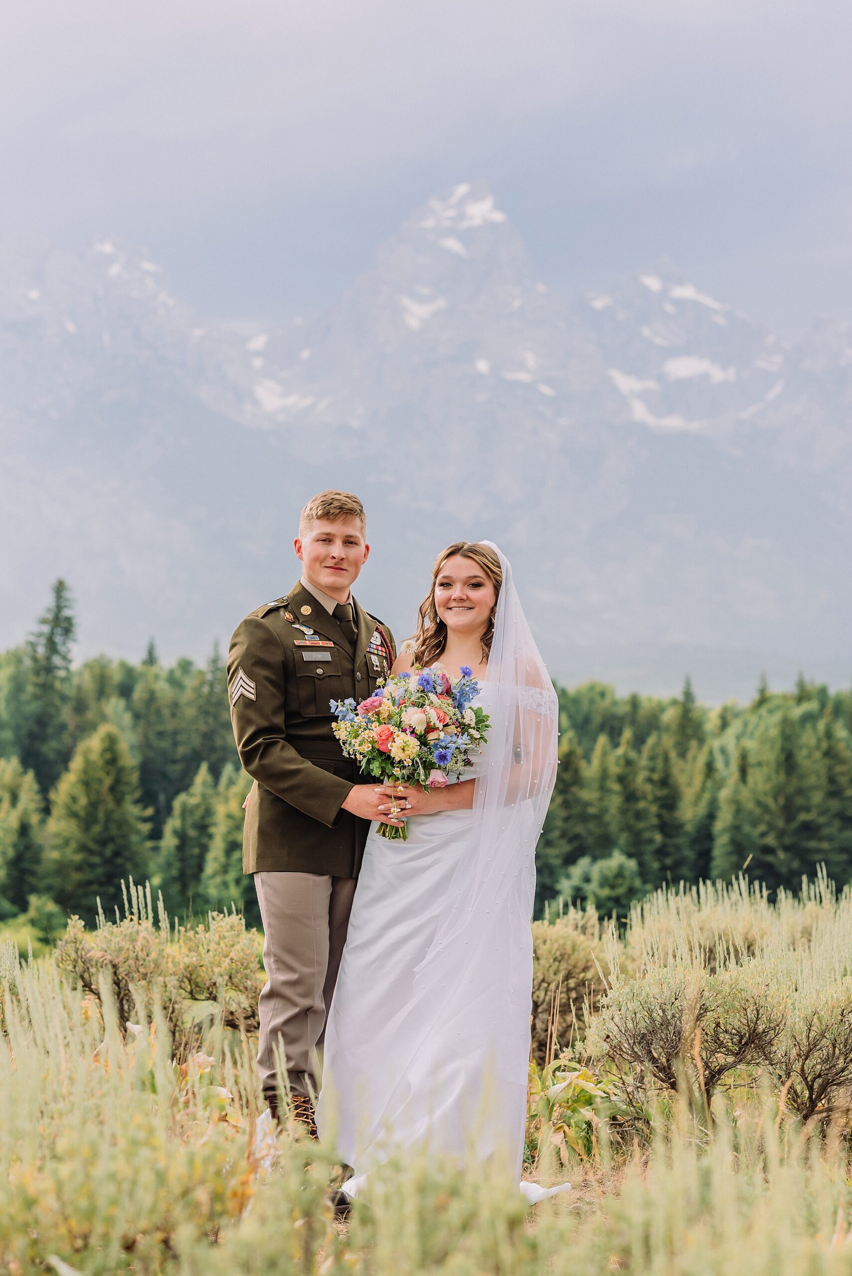 wedding couple poses eloping in jackson hole wyoming small wedding jackson hole summer wedding in grand teton national park snake river overlook wedding ceremony jackson hole wedding photographers blacktail ponds overlook