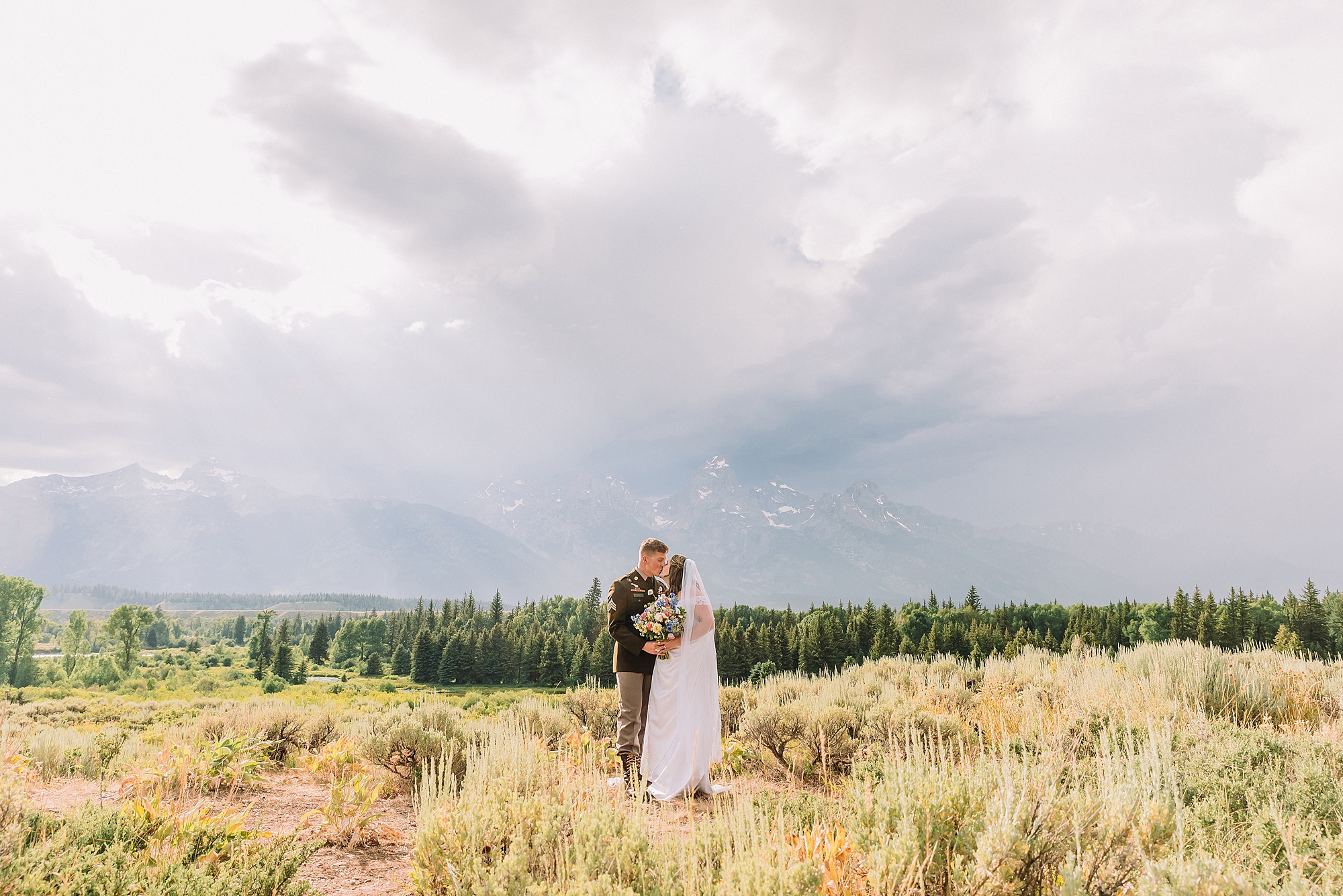 wedding couple poses eloping in jackson hole wyoming small wedding jackson hole summer wedding in grand teton national park snake river overlook wedding ceremony jackson hole wedding photographers blacktail ponds overlook