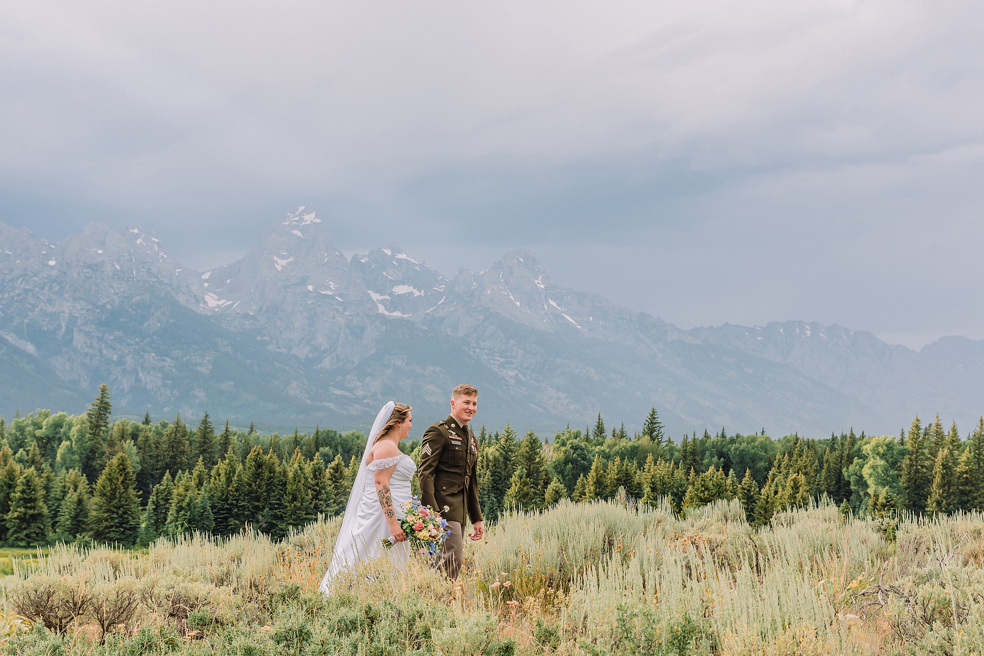wedding couple poses eloping in jackson hole wyoming small wedding jackson hole summer wedding in grand teton national park snake river overlook wedding ceremony jackson hole wedding photographers blacktail ponds overlook