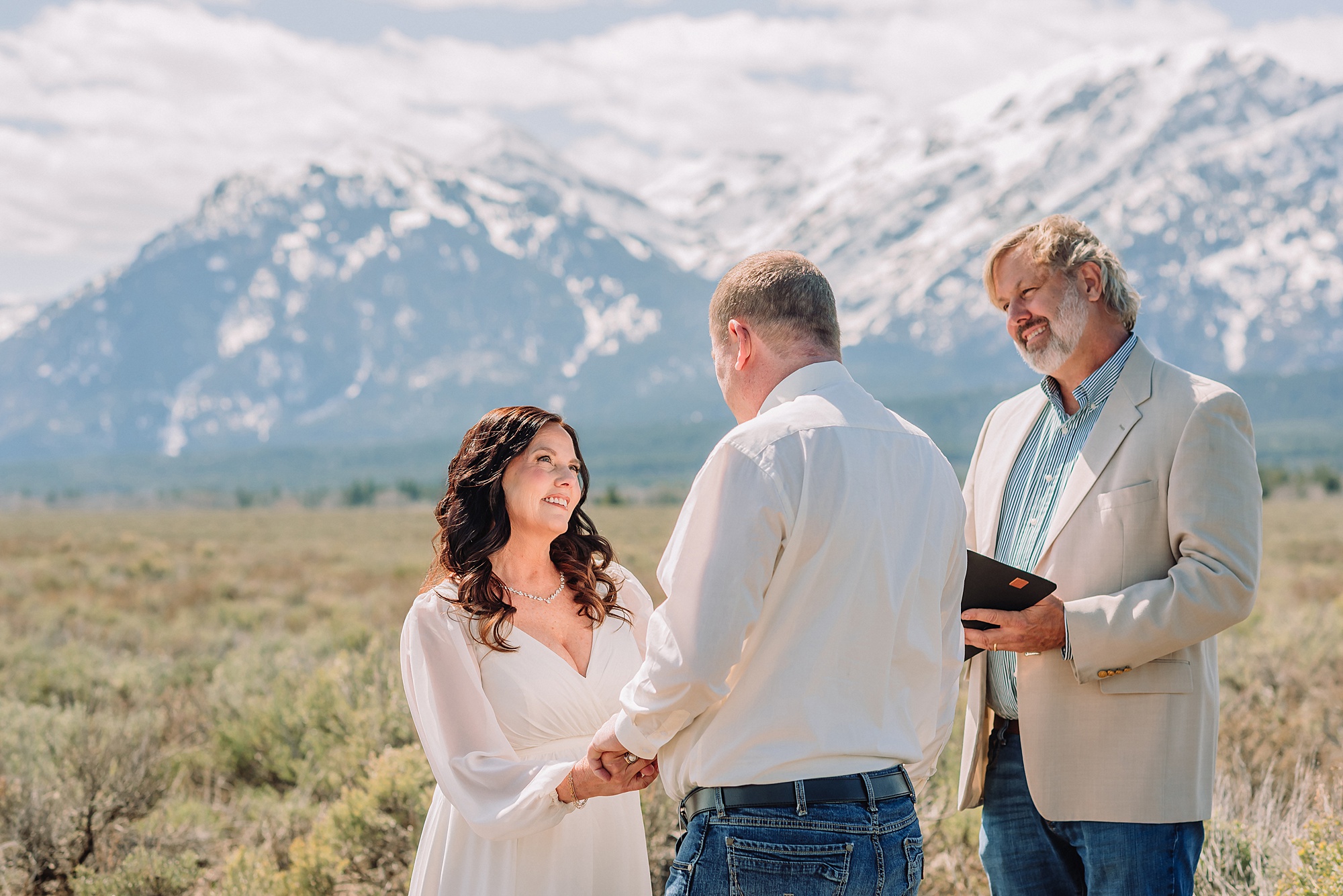 Grand Teton elopement at Albright View Turnout Pastor Ray officiant Grand Teton wedding ceremony Early May Grand Teton elopement photography Intimate mountain wedding with family witnesses