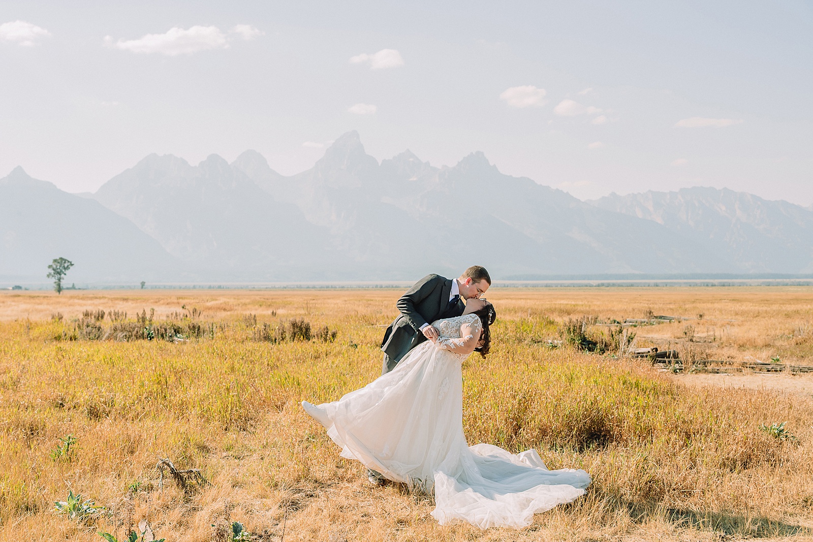 Mormon Row wedding portraits Jackson Hole bride in lace embroidered long sleeve wedding dress small intimate wedding ceremony ideas Mormon Row Grand Teton wedding ceremony