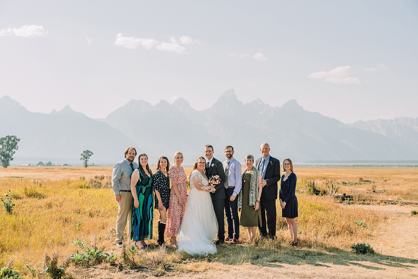 Mormon Row wedding portraits Jackson Hole bride in lace embroidered long sleeve wedding dress small intimate wedding ceremony ideas Mormon Row Grand Teton wedding ceremony