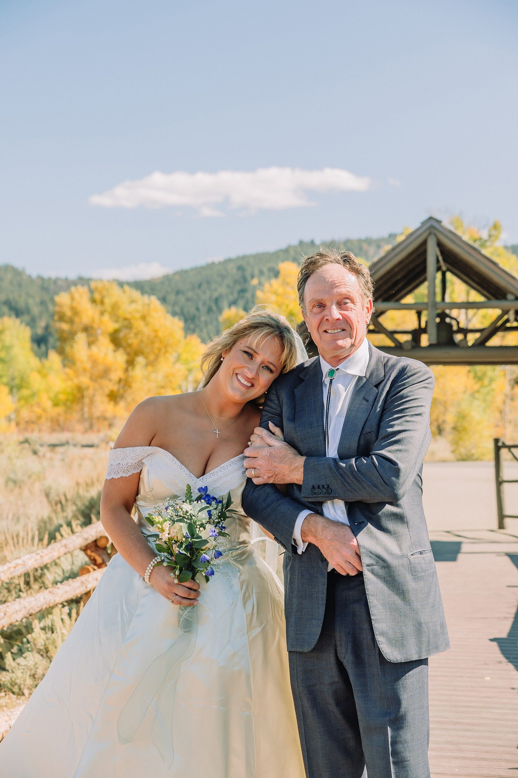 historic chapel wedding Wyoming mountains intimate wedding Chapel of the Transfiguration family photos Chapel of the Transfiguration wedding ceremony Grand Teton bride in mother's wedding dress teal boots fall wedding Chapel of the Transfiguration September Grand Teton National Park micro wedding
