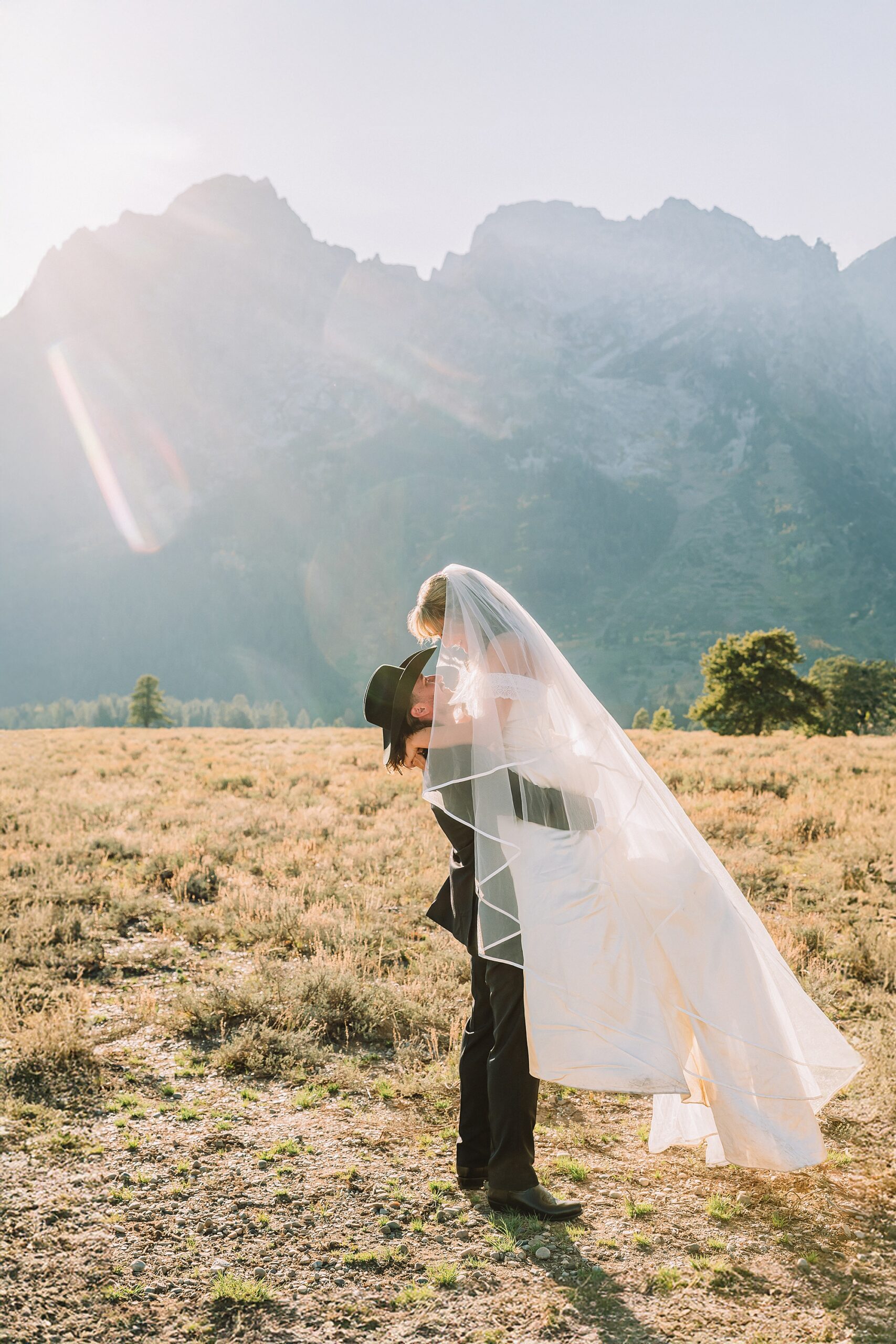 bride in mother's wedding dress teal boots bride groom cowboy hat bolo tie mountain wedding Cathedral Group Turnout wedding photos sagebrush String Lake wedding photography sunset late September wedding Grand Teton fall foliage