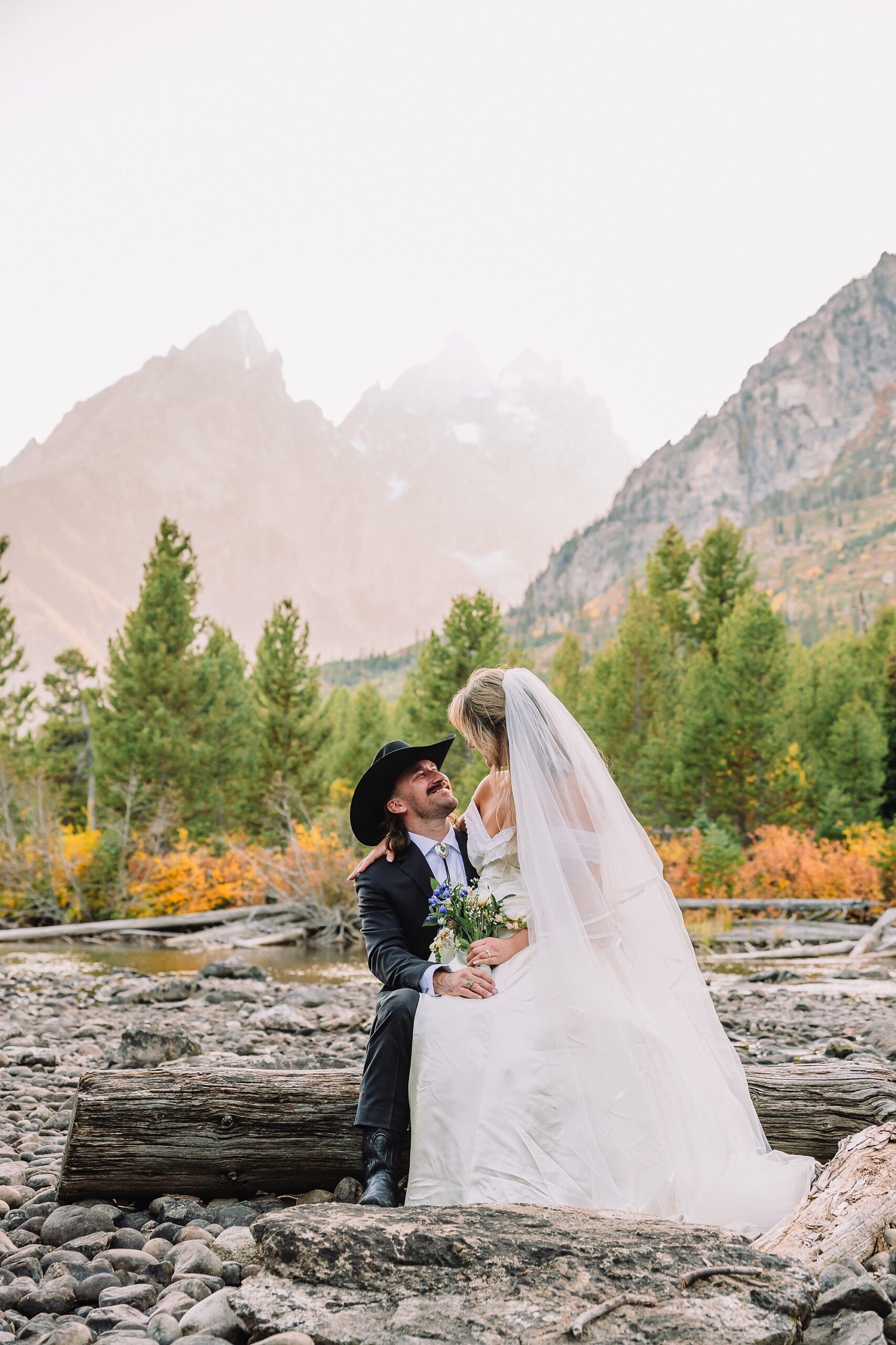 bride in mother's wedding dress teal boots bride groom cowboy hat bolo tie mountain wedding Cathedral Group Turnout wedding photos sagebrush String Lake wedding photography sunset late September wedding Grand Teton fall foliage
