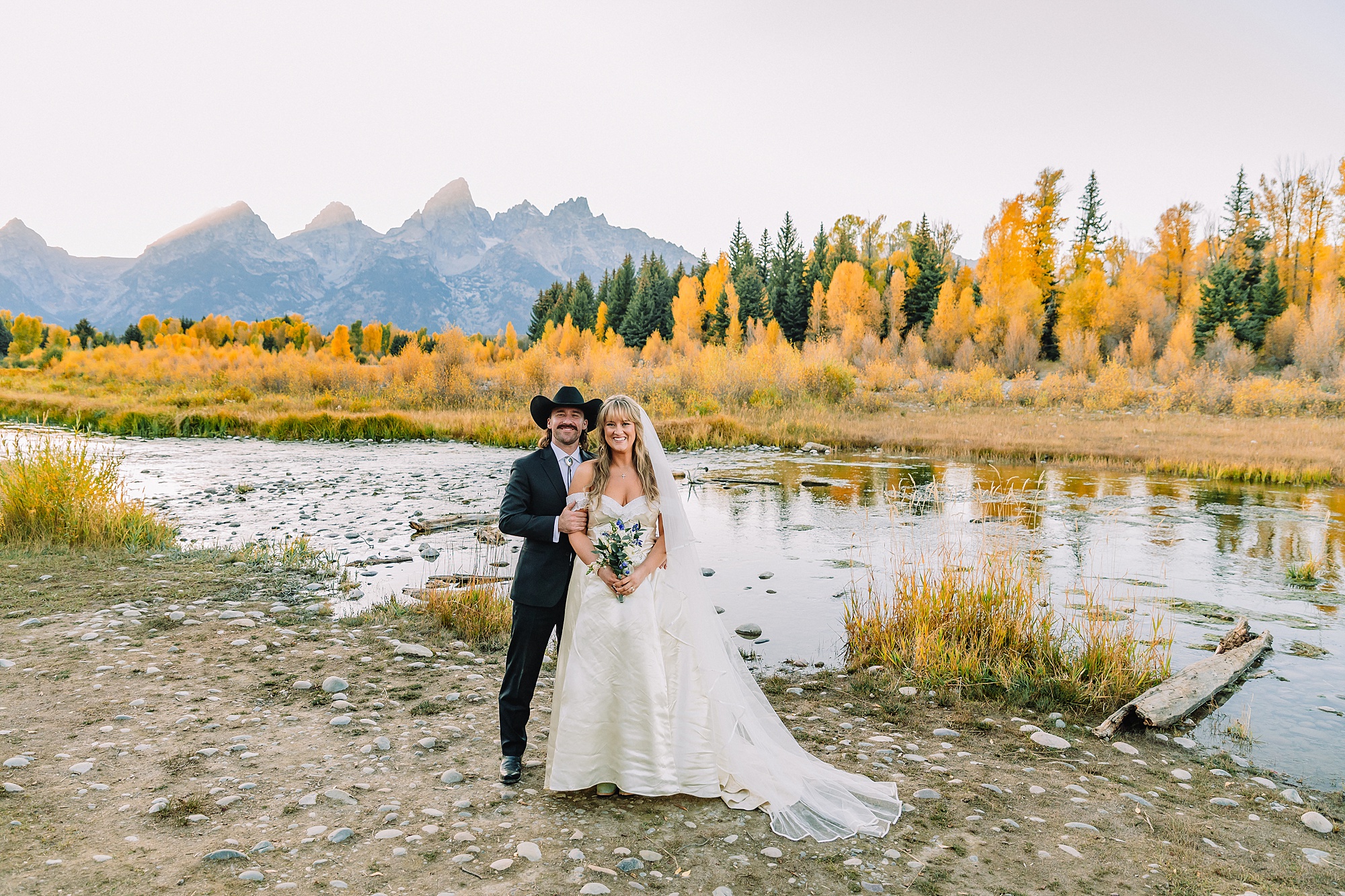 bride in mother's wedding dress teal boots bride groom cowboy hat bolo tie mountain wedding Cathedral Group Turnout wedding photos sagebrush String Lake wedding photography sunset late September wedding Grand Teton fall foliage