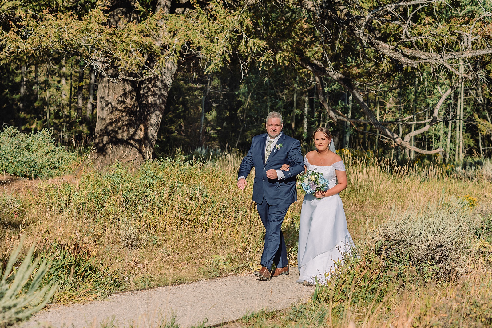 The Wedding Tree ceremony photos Wyoming bride wearing mother's wedding dress mountain elopement with Teton backdrop small intimate wedding ceremony ideas intimate outdoor Wyoming wedding inspiration