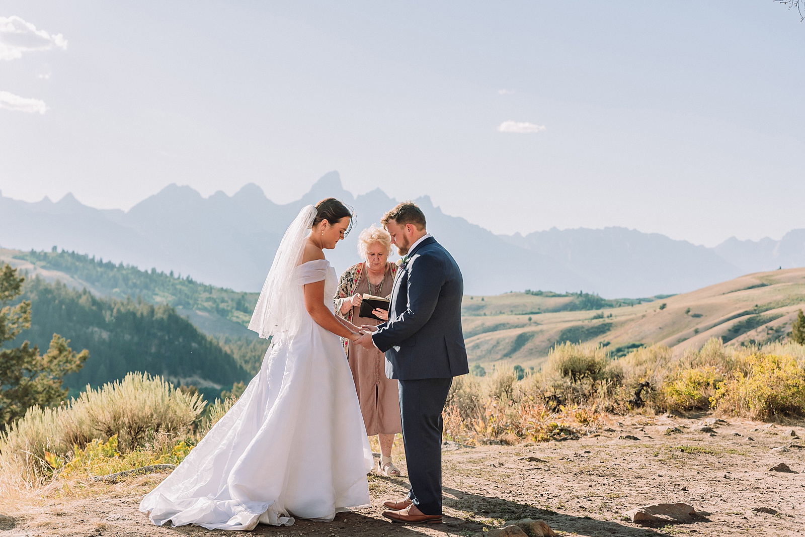 The Wedding Tree ceremony photos Wyoming bride wearing mother's wedding dress mountain elopement with Teton backdrop small intimate wedding ceremony ideas intimate outdoor Wyoming wedding inspiration