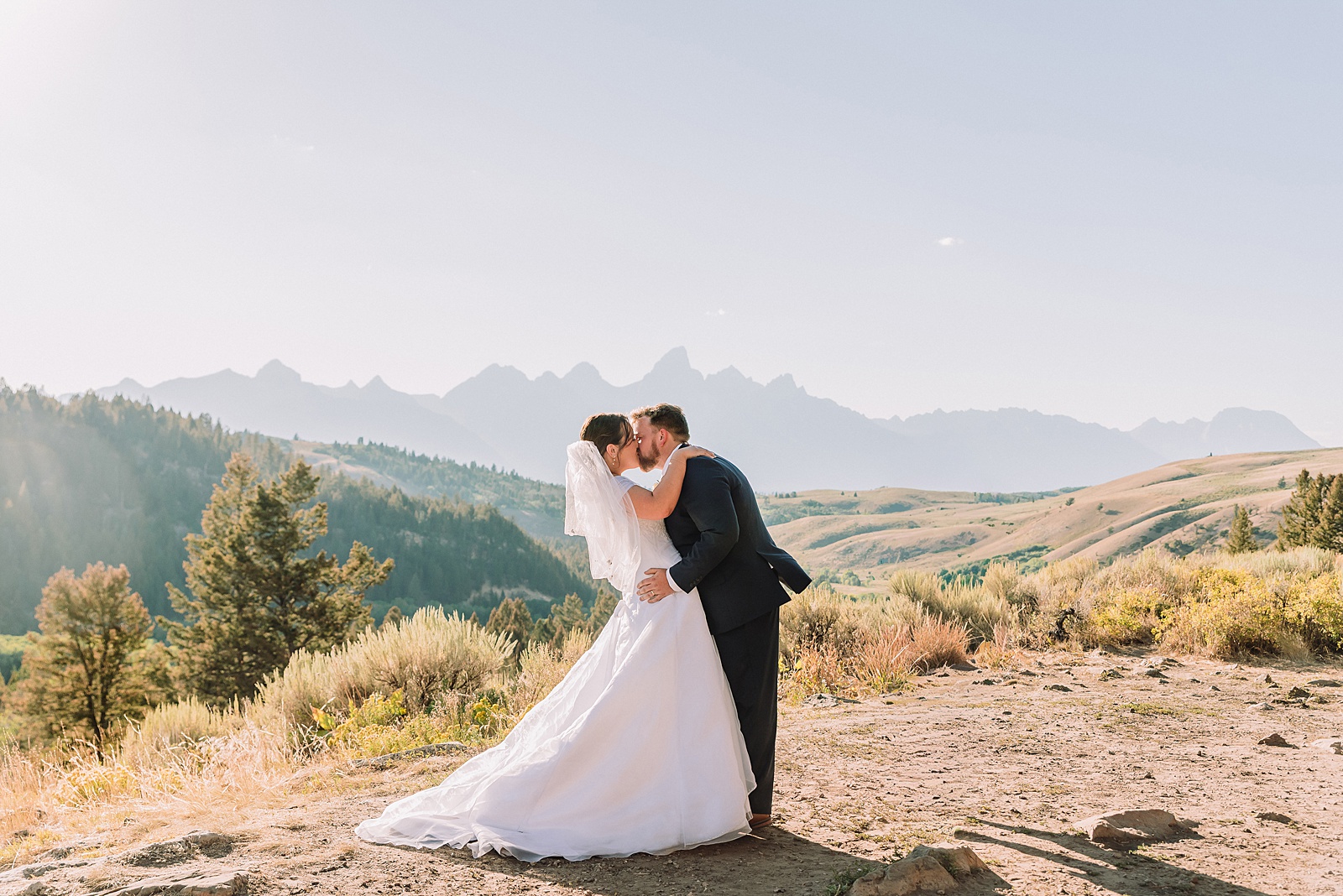 The Wedding Tree ceremony photos Wyoming bride wearing mother's wedding dress mountain elopement with Teton backdrop small intimate wedding ceremony ideas intimate outdoor Wyoming wedding inspiration