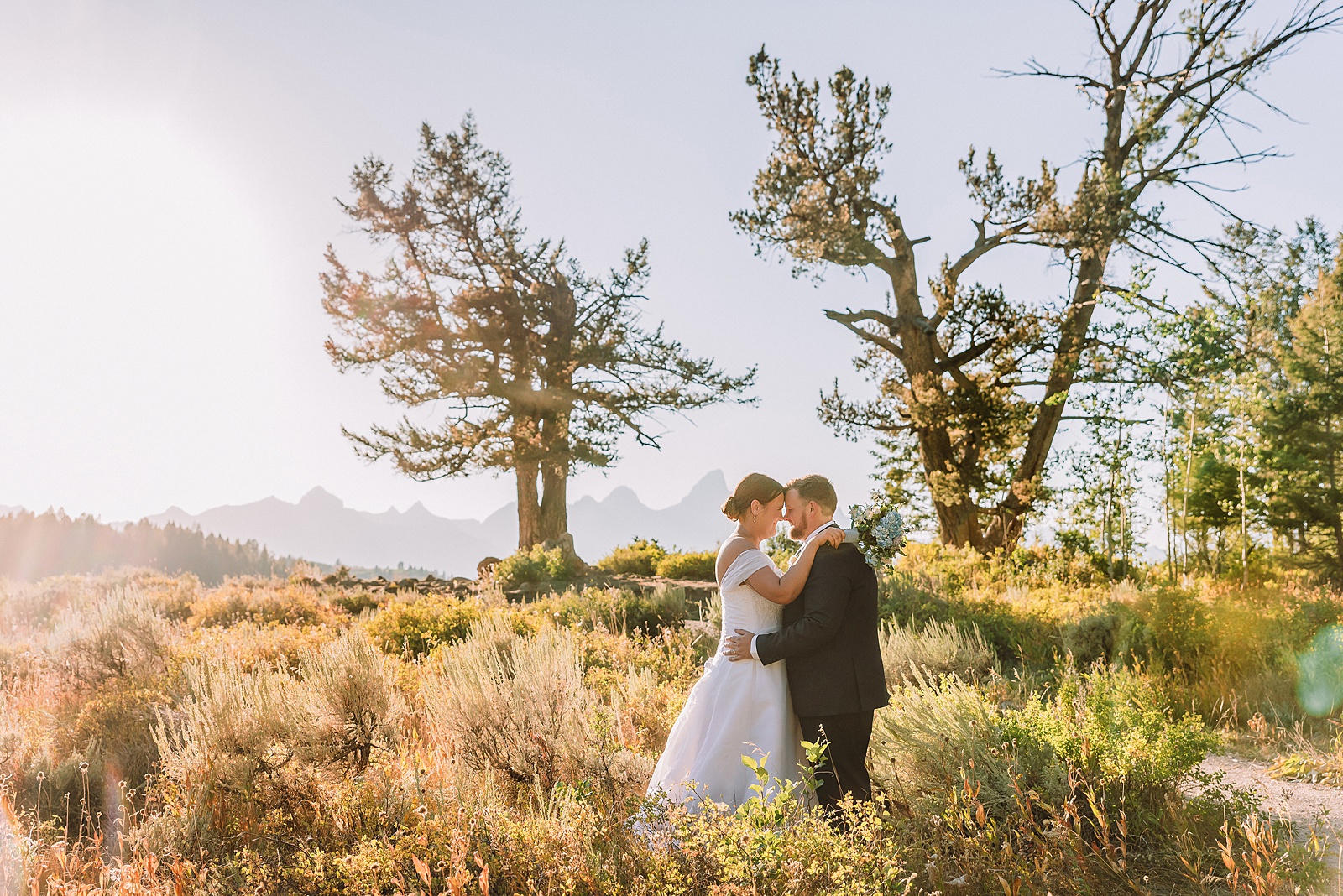 The Wedding Tree ceremony photos Wyoming bride wearing mother's wedding dress mountain elopement with Teton backdrop small intimate wedding ceremony ideas intimate outdoor Wyoming wedding inspiration