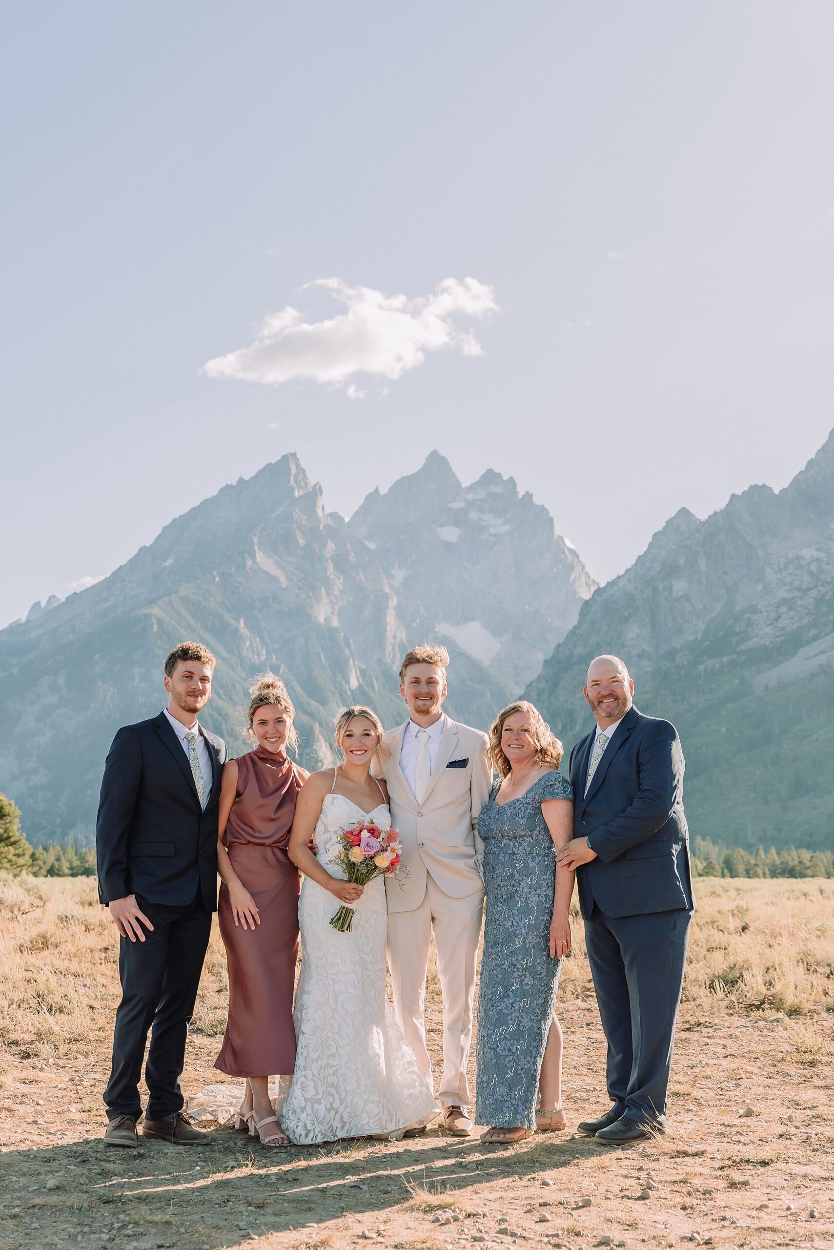 Cathedral View Turnout elopement ceremony Grand Teton National Park bride on horse Grand Teton elopement couple running down road Grand Teton elopement Jackson Hole micro wedding photographer how to get married in grand teton national park western wedding at Cathedral View Turnout horses in western wedding jackson hole