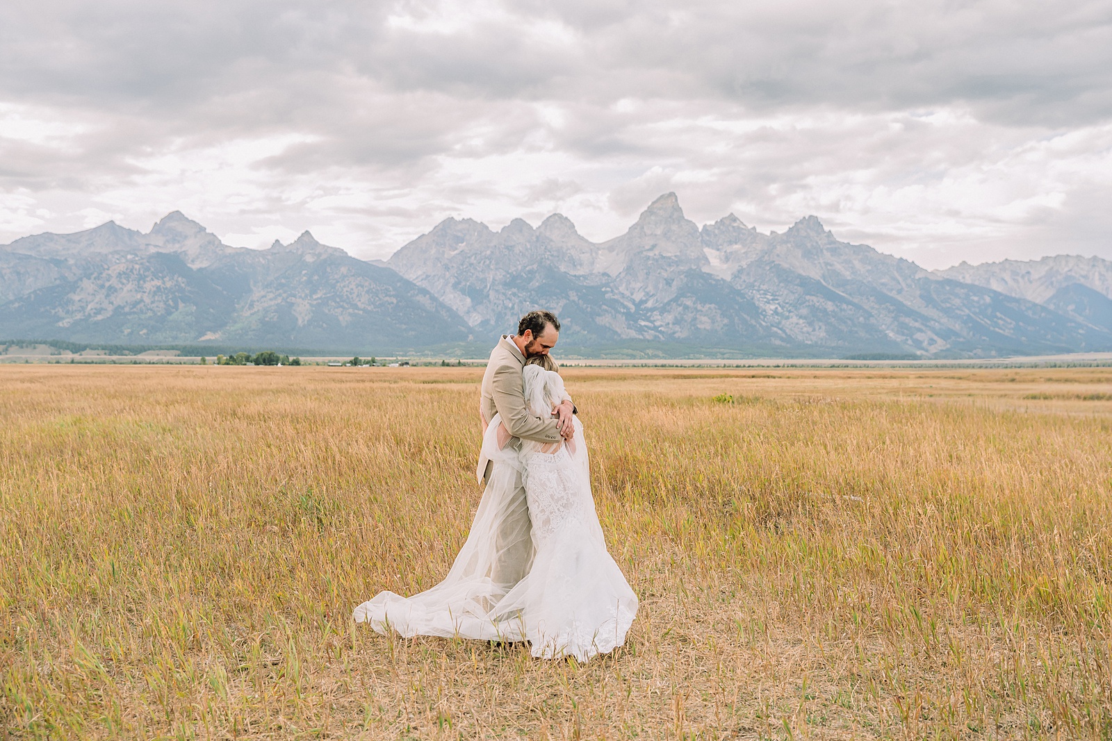Mormon Row Grand Teton wedding ceremony cathedral veil alpine wedding photography fall colors Grand Teton elopement intimate outdoor micro wedding Wyoming champagne toast Grand Teton wedding celebration semi-formal outdoor alpine wedding attire first look Mormon Row Grand Tetons