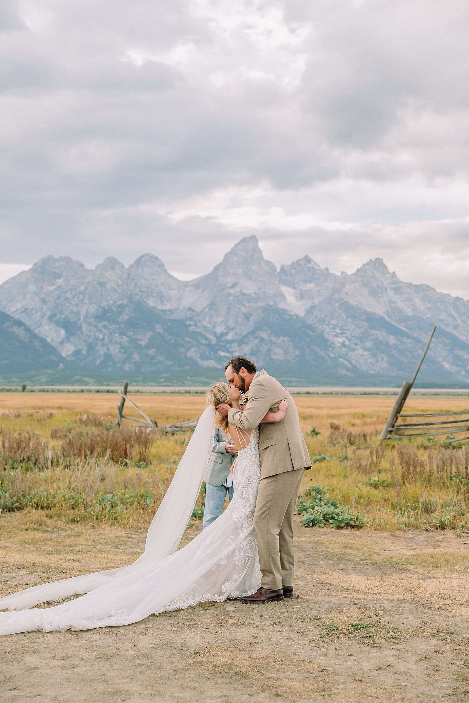 Mormon Row Grand Teton wedding ceremony cathedral veil alpine wedding photography fall colors Grand Teton elopement intimate outdoor micro wedding Wyoming champagne toast Grand Teton wedding celebration semi-formal outdoor alpine wedding attire first look Mormon Row Grand Tetons