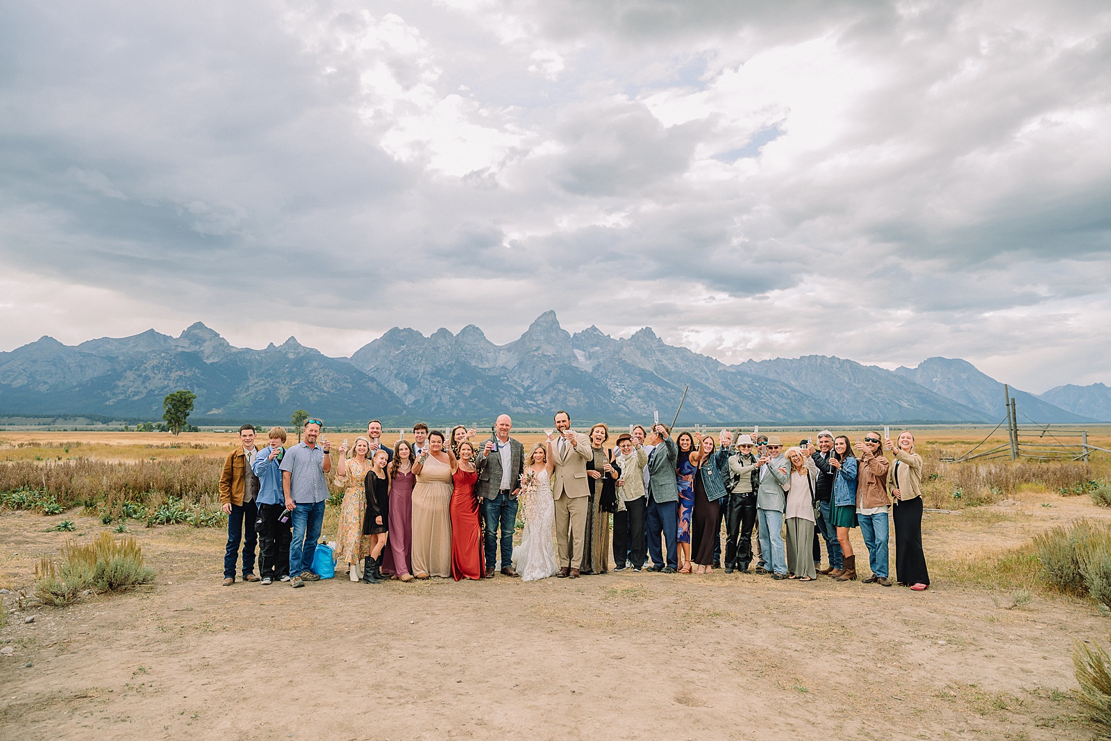 Mormon Row Grand Teton wedding ceremony cathedral veil alpine wedding photography fall colors Grand Teton elopement intimate outdoor micro wedding Wyoming champagne toast Grand Teton wedding celebration semi-formal outdoor alpine wedding attire first look Mormon Row Grand Tetons