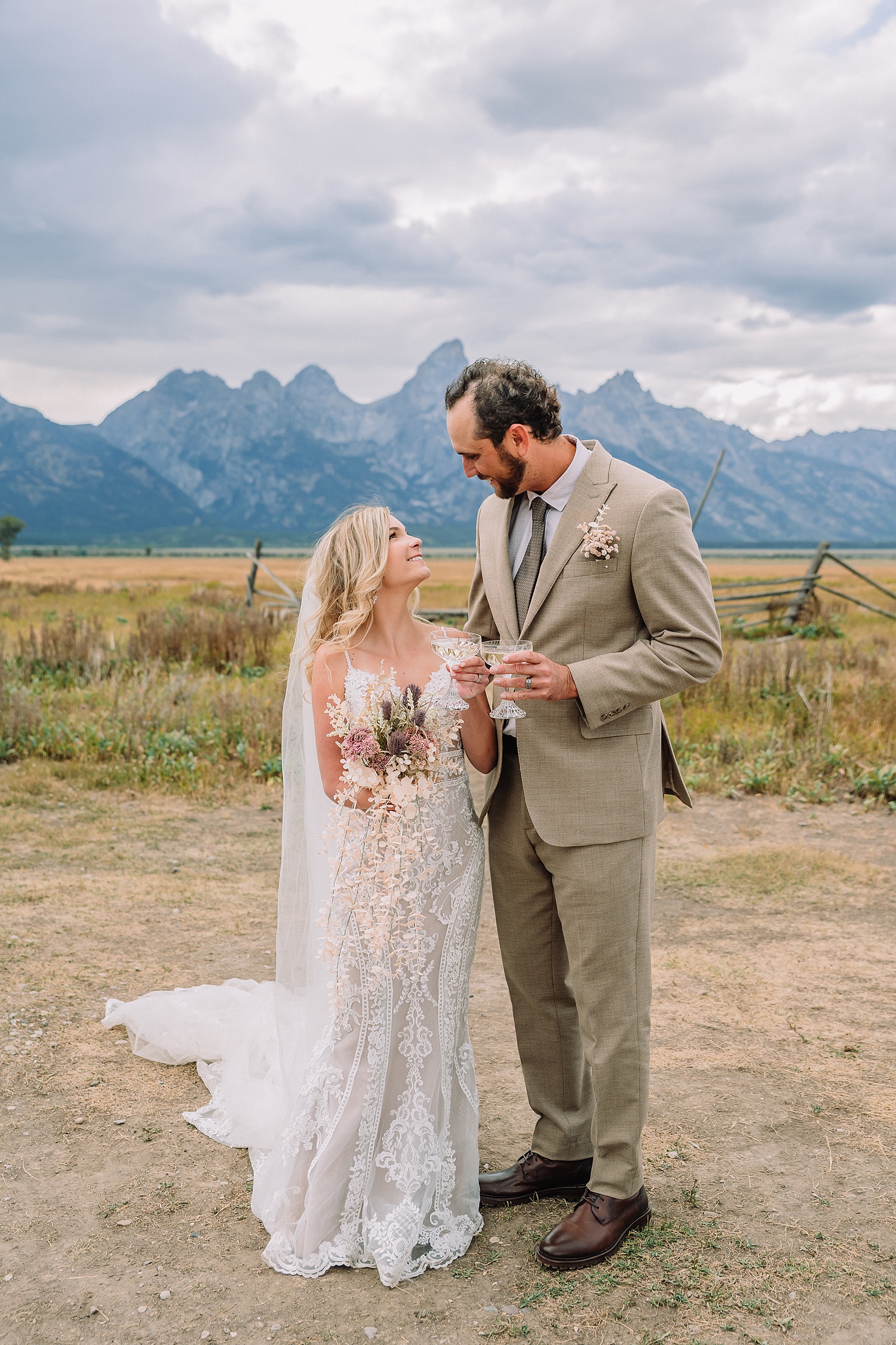 Mormon Row Grand Teton wedding ceremony cathedral veil alpine wedding photography fall colors Grand Teton elopement intimate outdoor micro wedding Wyoming champagne toast Grand Teton wedding celebration semi-formal outdoor alpine wedding attire first look Mormon Row Grand Tetons