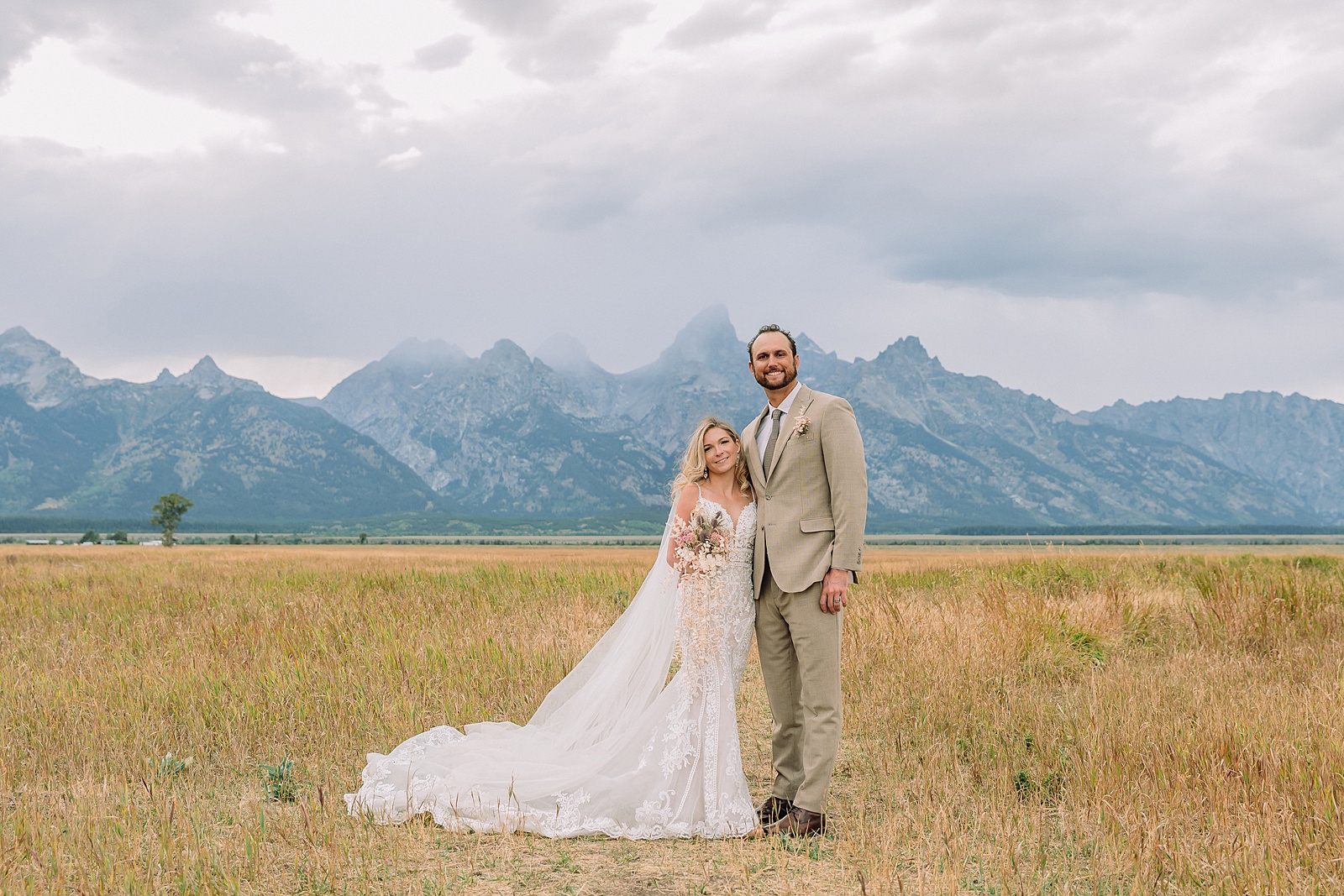 Mormon Row Grand Teton wedding ceremony cathedral veil alpine wedding photography fall colors Grand Teton elopement intimate outdoor micro wedding Wyoming champagne toast Grand Teton wedding celebration semi-formal outdoor alpine wedding attire first look Mormon Row Grand Tetons