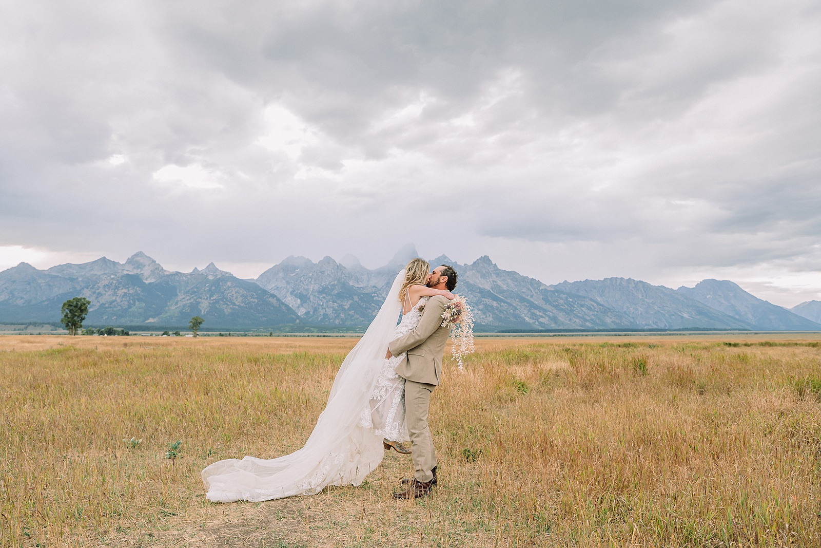 Mormon Row Grand Teton wedding ceremony cathedral veil alpine wedding photography fall colors Grand Teton elopement intimate outdoor micro wedding Wyoming champagne toast Grand Teton wedding celebration semi-formal outdoor alpine wedding attire first look Mormon Row Grand Tetons