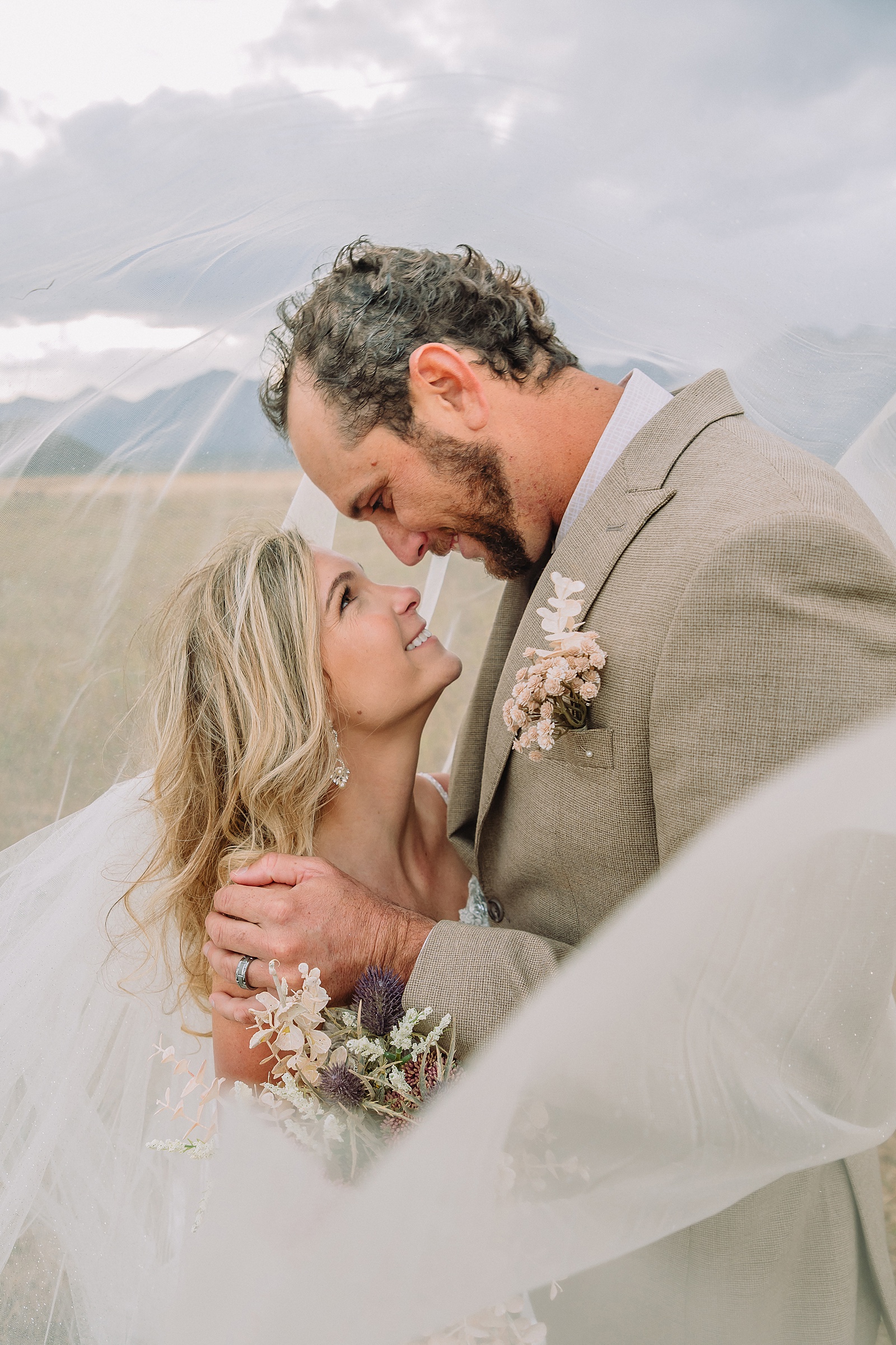 Mormon Row Grand Teton wedding ceremony cathedral veil alpine wedding photography fall colors Grand Teton elopement intimate outdoor micro wedding Wyoming champagne toast Grand Teton wedding celebration semi-formal outdoor alpine wedding attire first look Mormon Row Grand Tetons