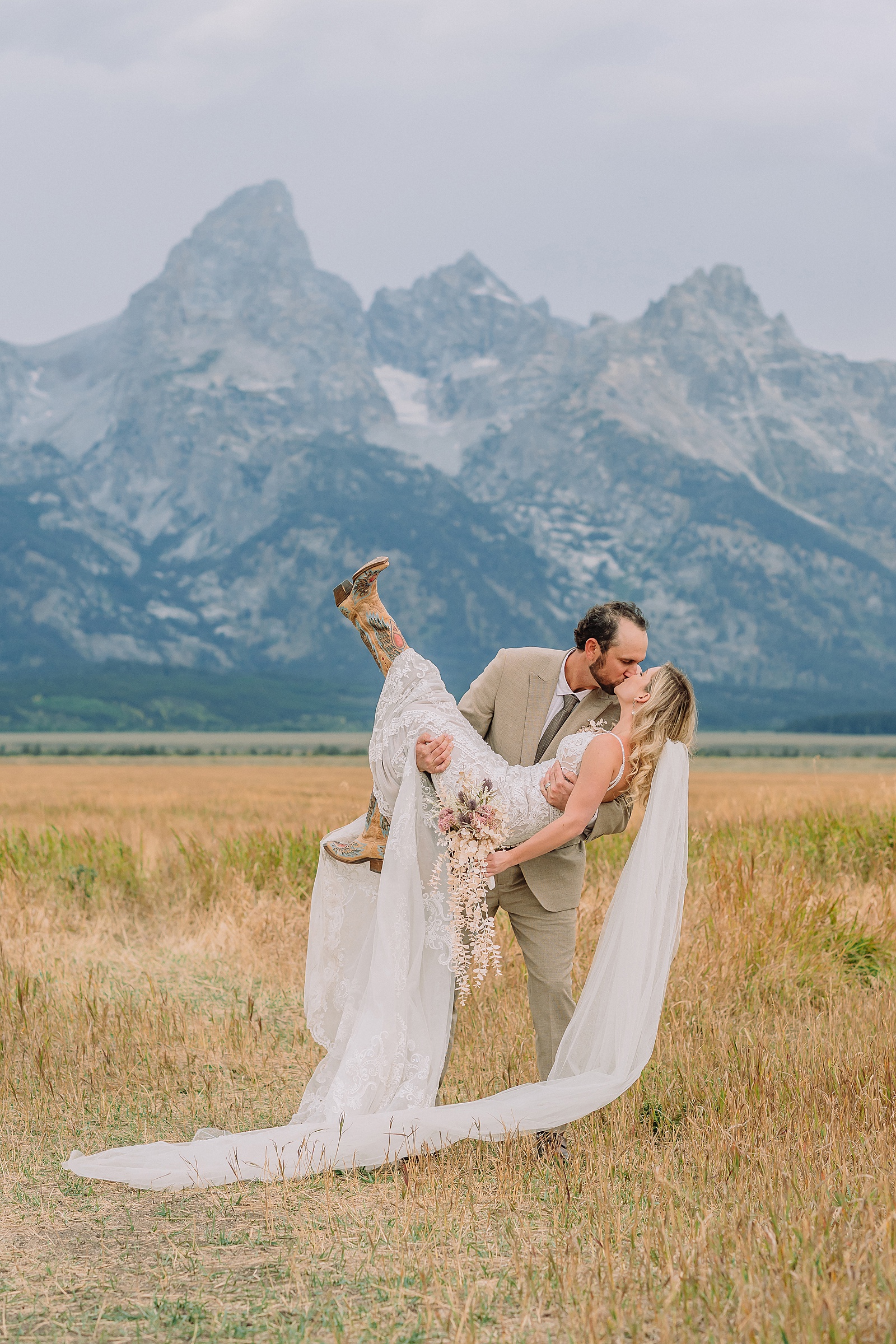 Mormon Row Grand Teton wedding ceremony cathedral veil alpine wedding photography fall colors Grand Teton elopement intimate outdoor micro wedding Wyoming champagne toast Grand Teton wedding celebration semi-formal outdoor alpine wedding attire first look Mormon Row Grand Tetons