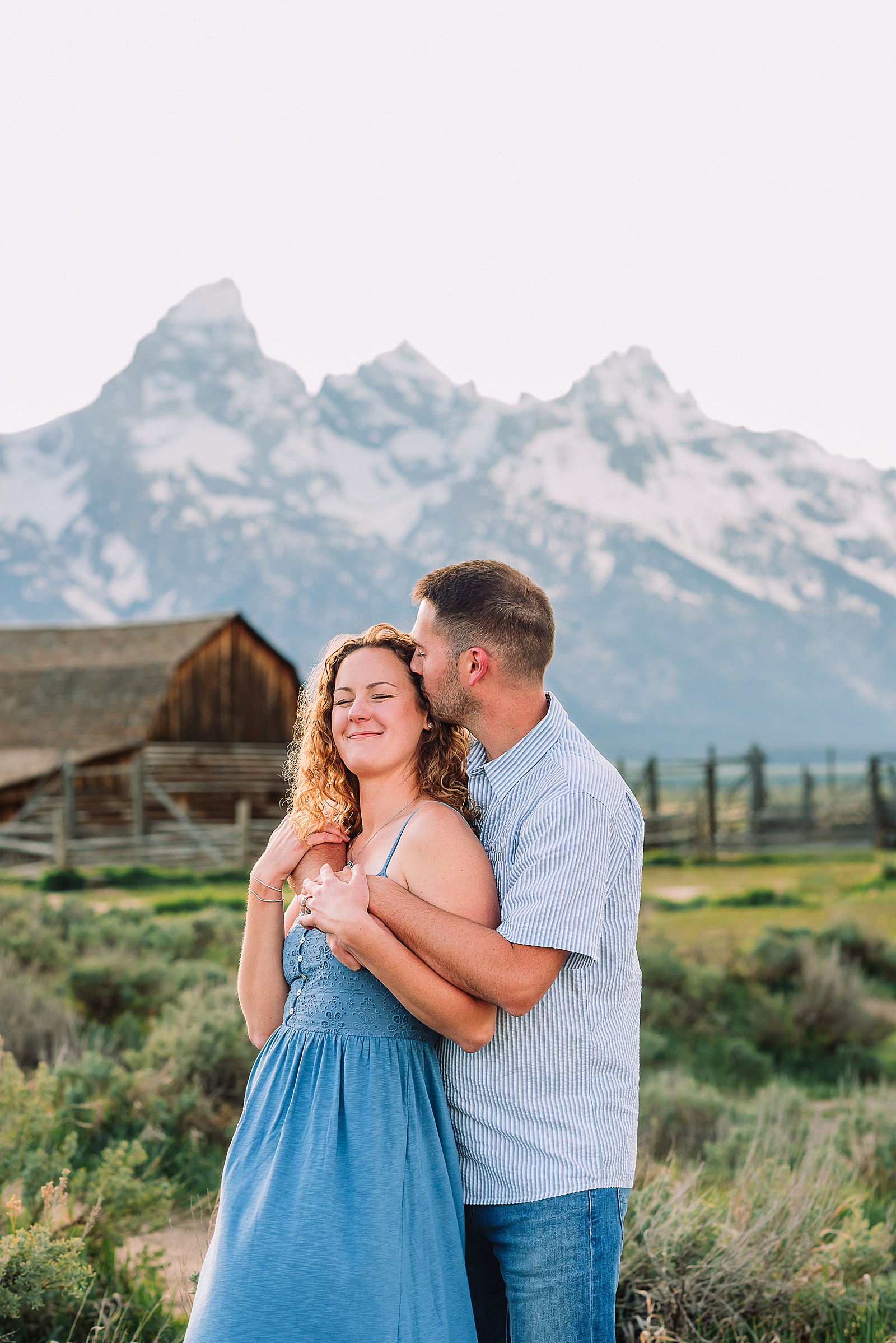 golden hour couples photography Mormon Row Jackson Hole Teton mountain backdrop engagement photos Wyoming blue coordinated outfits couples portraits Grand Tetons historic barn couples photography Jackson Hole Wyoming spring aspen trees anniversary session Mormon Row rustic fence line portraits Grand Teton National Park