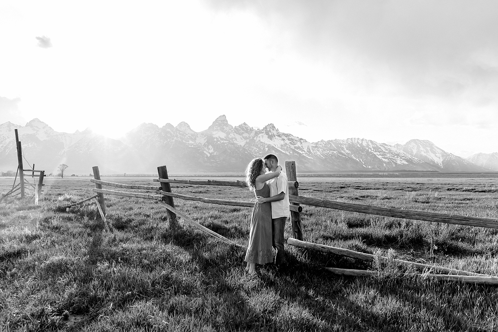 golden hour couples photography Mormon Row Jackson Hole Teton mountain backdrop engagement photos Wyoming blue coordinated outfits couples portraits Grand Tetons historic barn couples photography Jackson Hole Wyoming spring aspen trees anniversary session Mormon Row rustic fence line portraits Grand Teton National Park