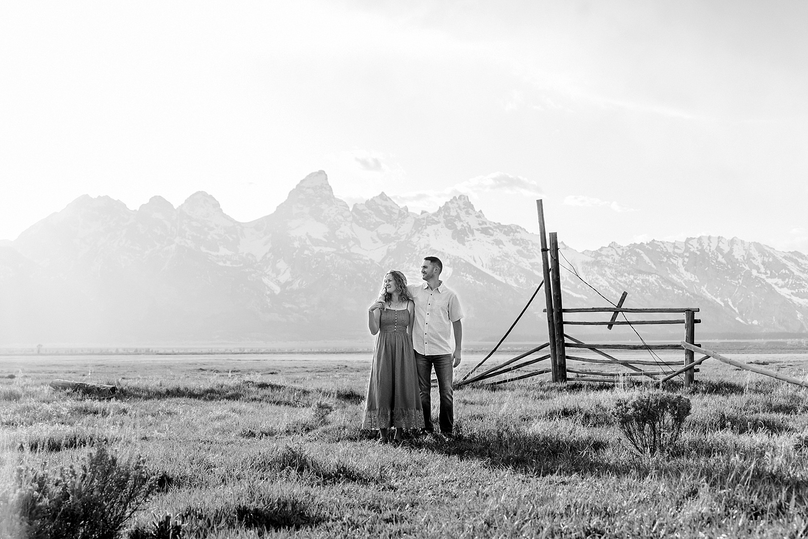 golden hour couples photography Mormon Row Jackson Hole Teton mountain backdrop engagement photos Wyoming blue coordinated outfits couples portraits Grand Tetons historic barn couples photography Jackson Hole Wyoming spring aspen trees anniversary session Mormon Row rustic fence line portraits Grand Teton National Park