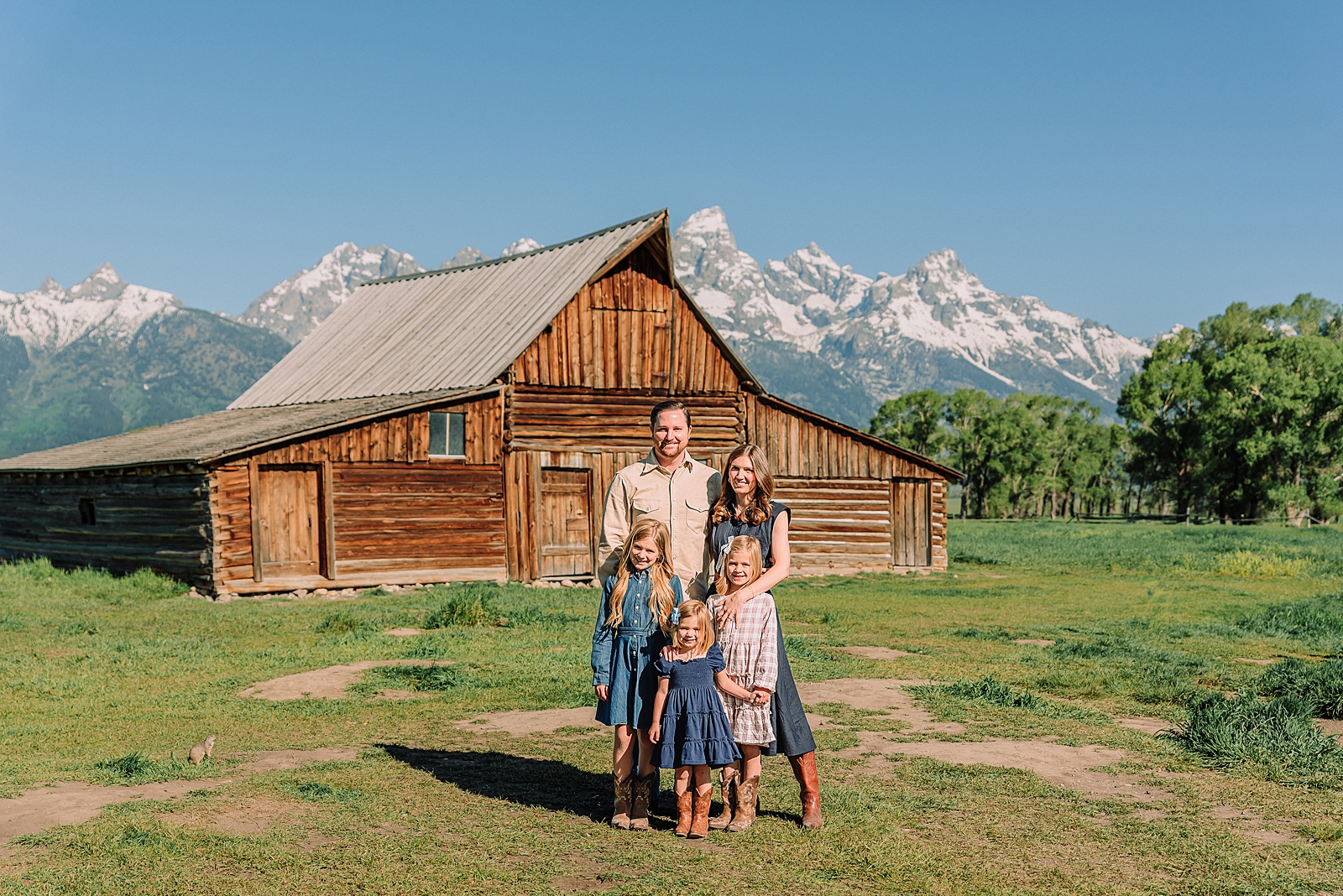 Jackson Hole Family Photos family photos at Mormon Row Wyoming Teton Range family portraits with historic barn Mormon Row south barn family pictures rustic barn backdrop family portraits Wyoming