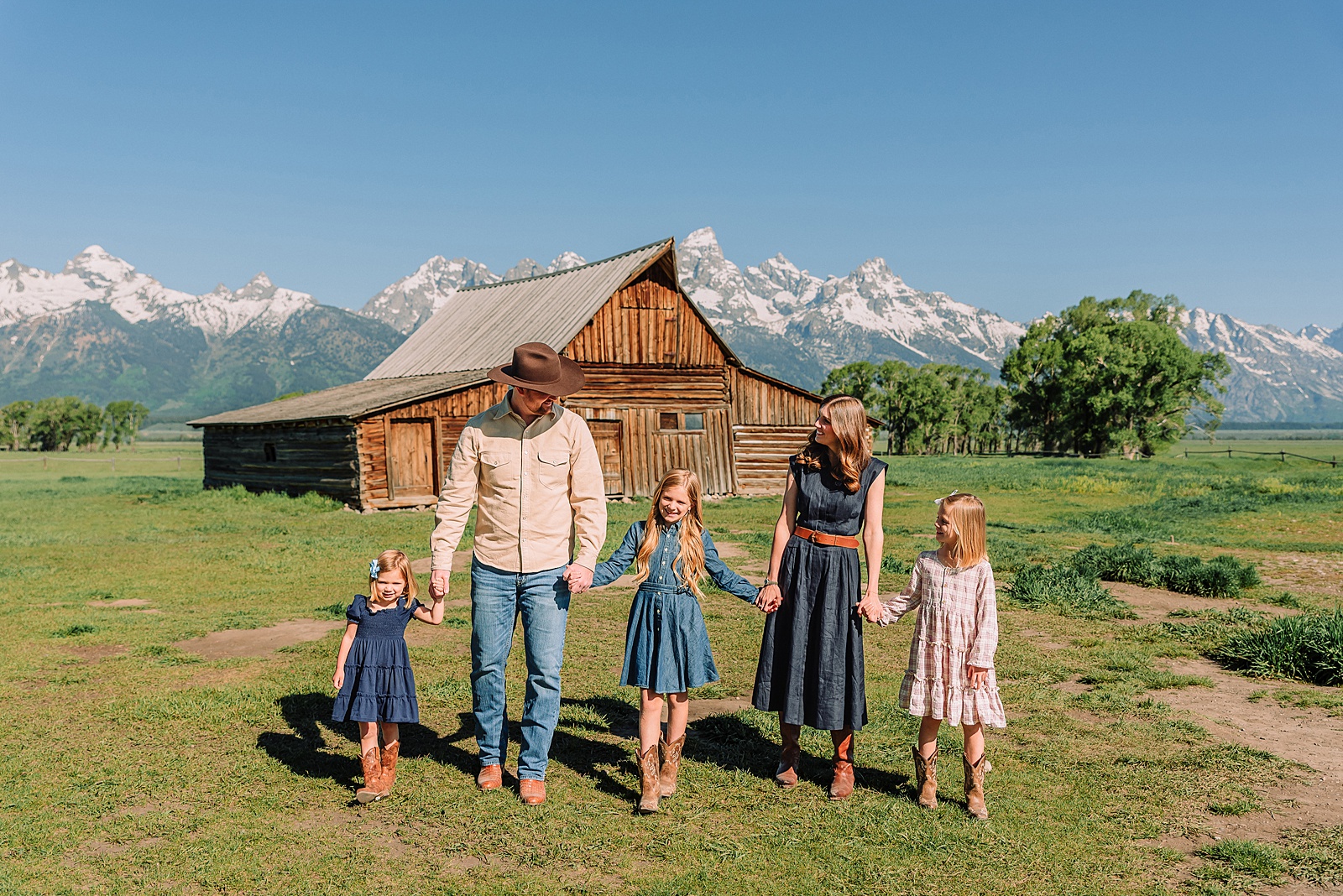 Jackson Hole Family Photos family photos at Mormon Row Wyoming Teton Range family portraits with historic barn Mormon Row south barn family pictures rustic barn backdrop family portraits Wyoming