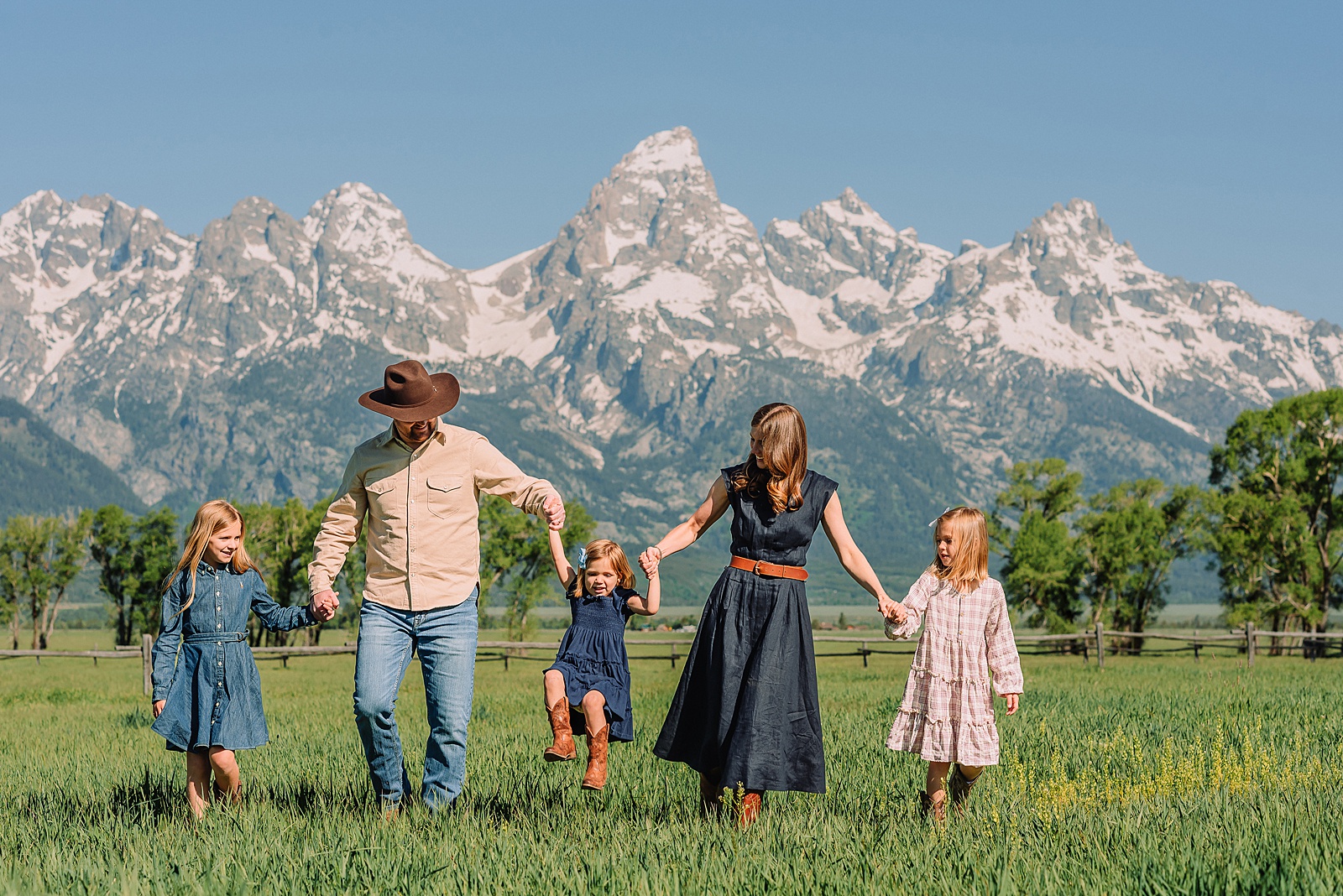 Jackson Hole Family Photos family photos at Mormon Row Wyoming Teton Range family portraits with historic barn Mormon Row south barn family pictures rustic barn backdrop family portraits Wyoming