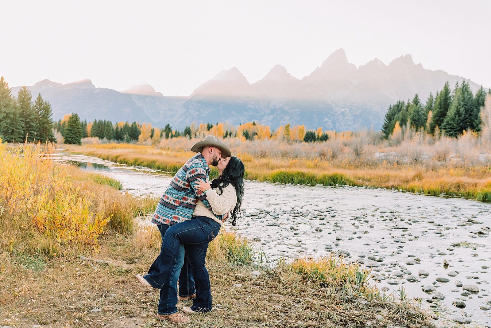 couple wearing custom engraved western hats at Grand Teton elopement turquoise wedding jewelry details at Jackson Hole mountain wedding horseback riding wedding party tour at Spring Creek Ranch Wyoming Schwabacher Landing sunset elopement portraits in Grand Teton National Park casual outfit change for relaxed mountain elopement photos split day wedding coverage for destination elopement couples flexible elopement timeline for Jackson Hole micro wedding western jeans and sweater look for Wyoming vacation style portraits